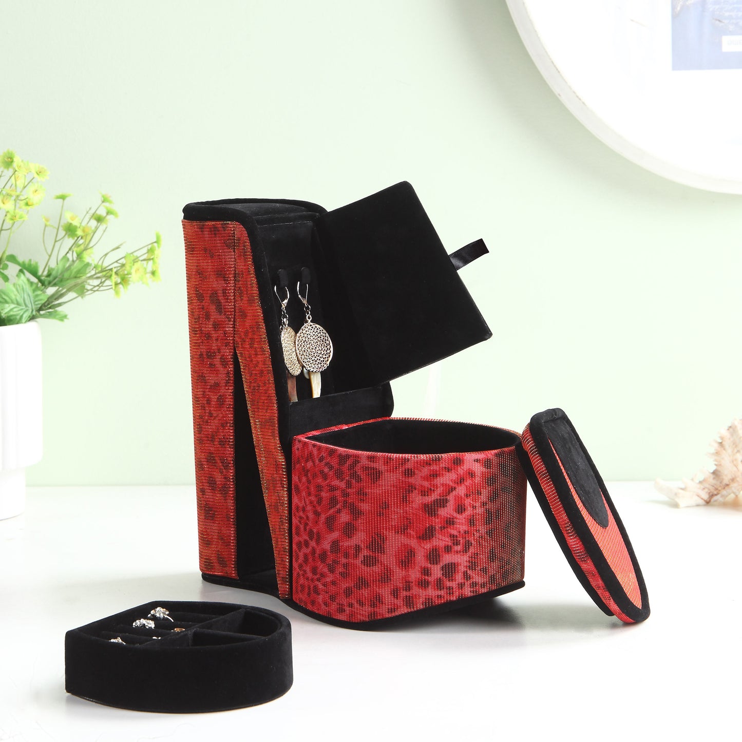 Red leopard print jewelry box with silver earrings displayed