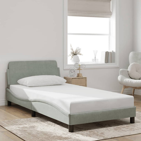 Sage green fabric single bed frame with curved headboard and white mattress