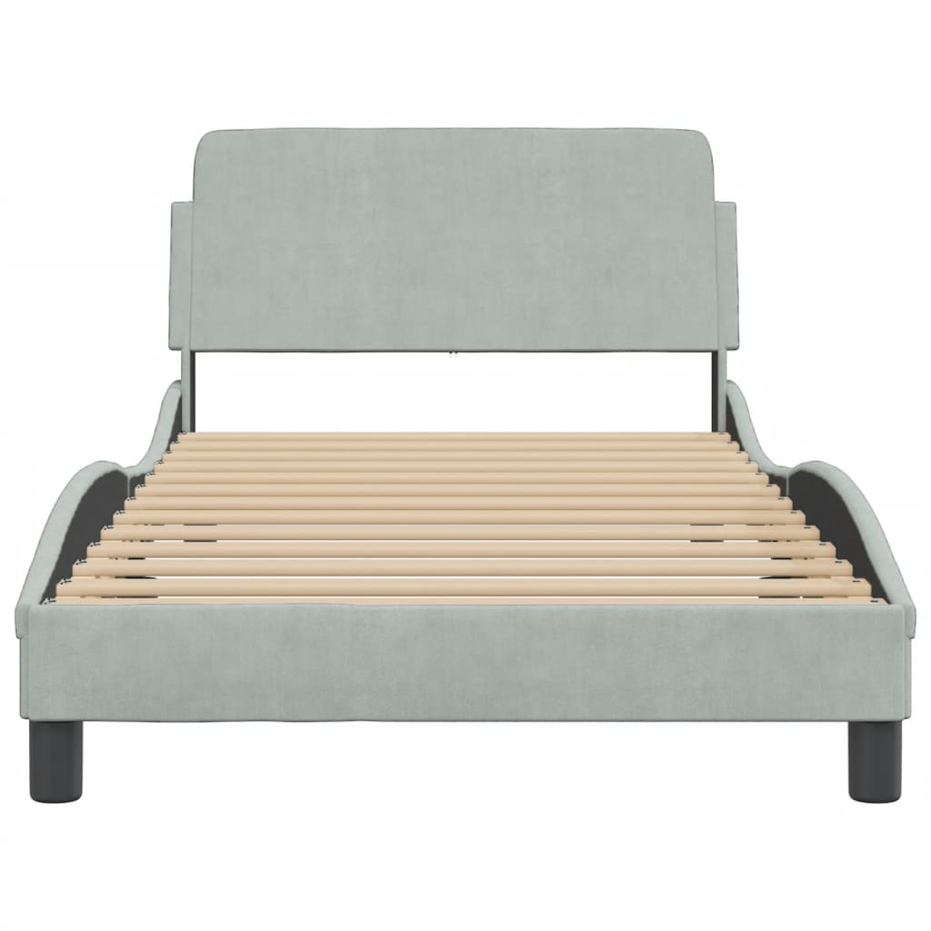 Pale blue upholstered daybed with wooden slats and black legs