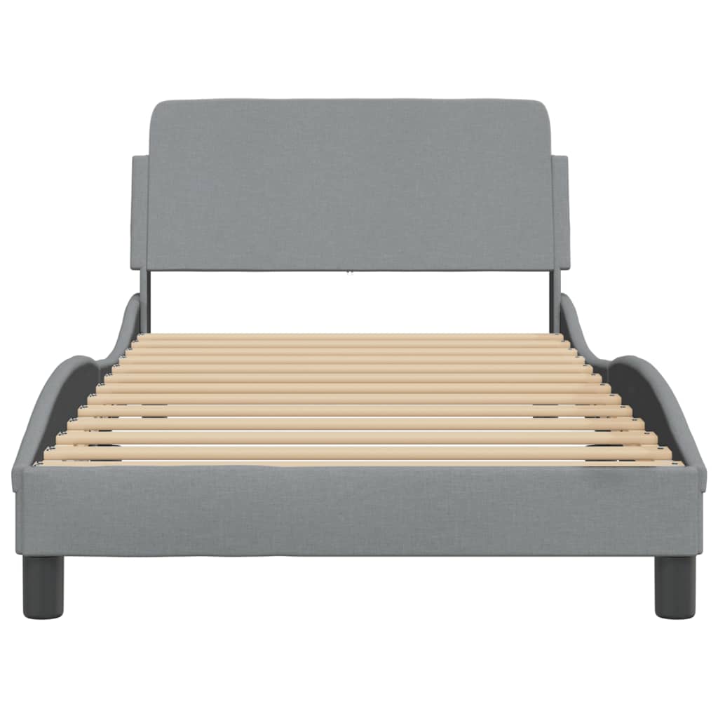 Grey upholstered bed frame with a modern curved headboard and wooden slats