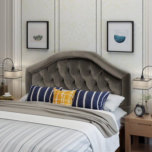 Tufted charcoal grey velvet headboard with silver studding detail creating a luxurious bedroom centerpiece