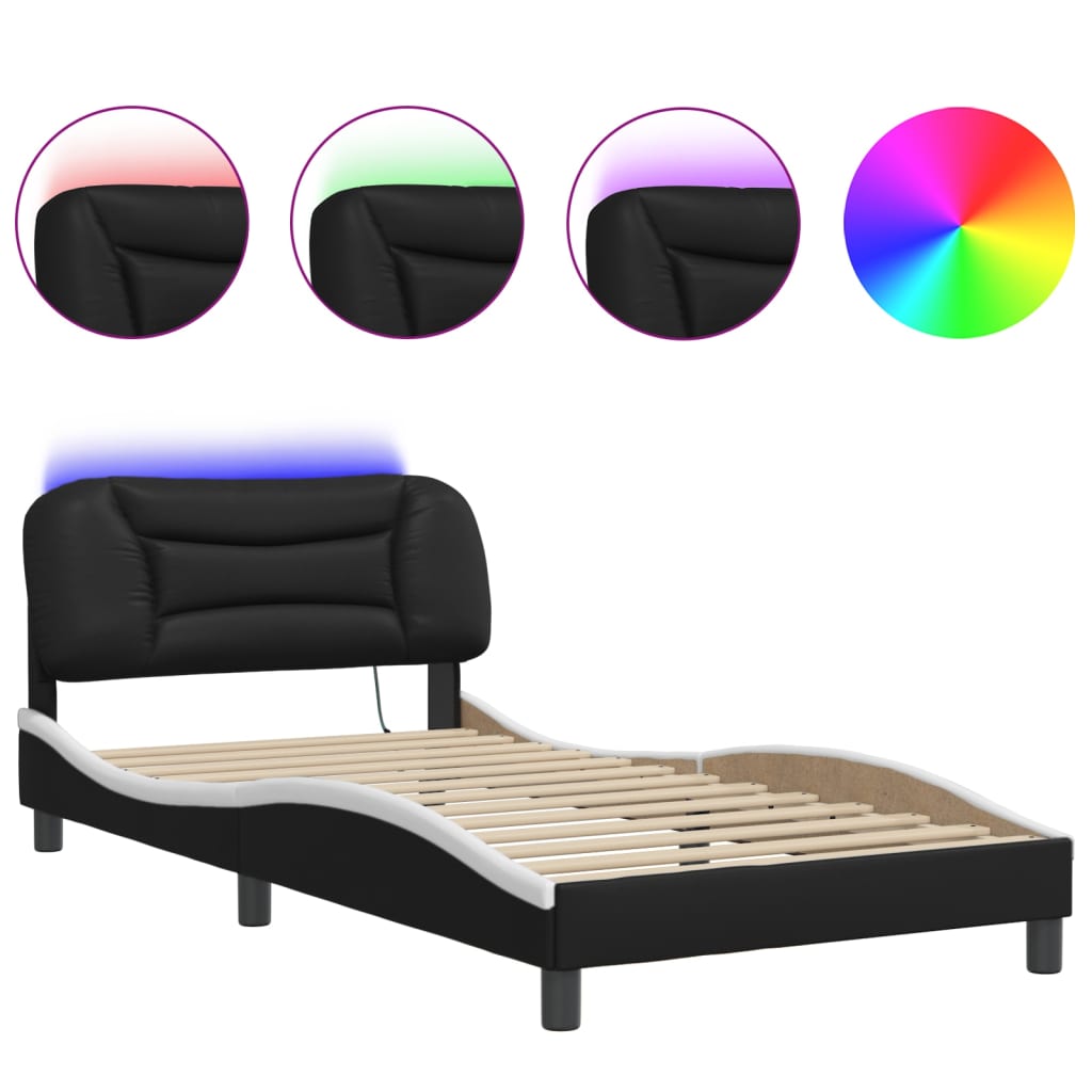 Closeup of a black upholstered bed frame corner with a wooden slat and a round black leg