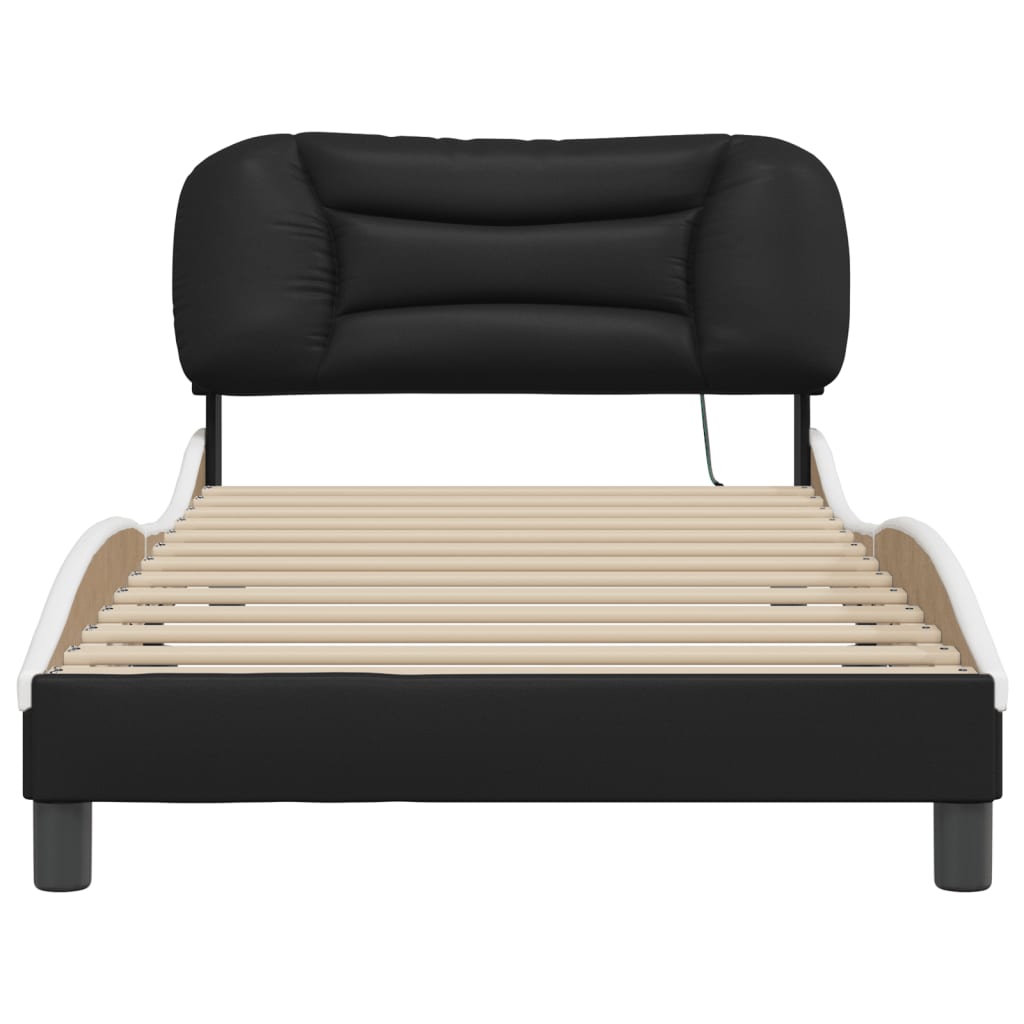 Black upholstered twin bed with a curved headboard and white mattress
