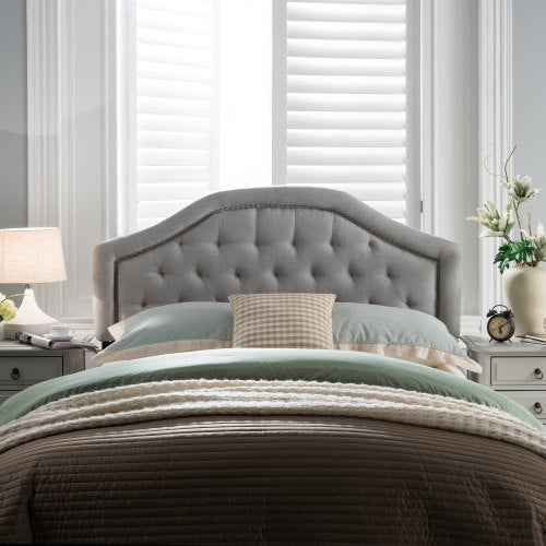 Tufted grey upholstered headboard with studded trim