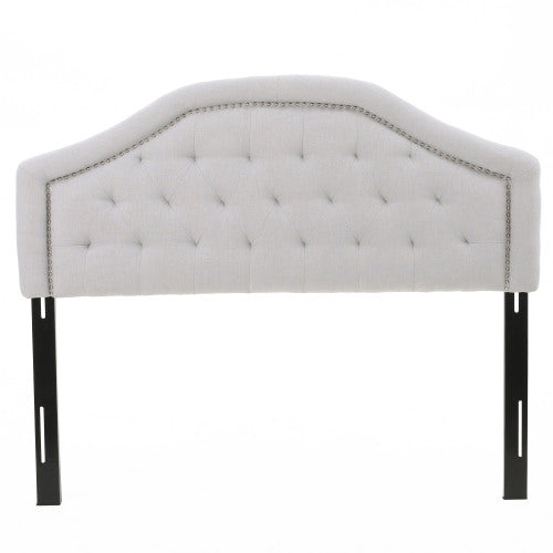 Tufted linen headboard with nailhead trim and black metal legs