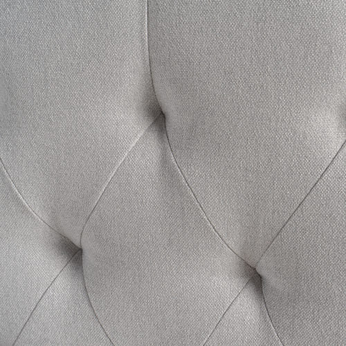 Closeup of light grey tufted upholstery fabric texture for furniture