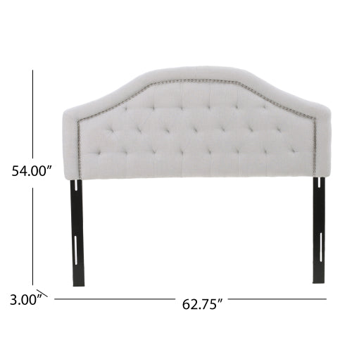 Light gray tufted upholstered headboard with silver nailhead trim and black metal legs