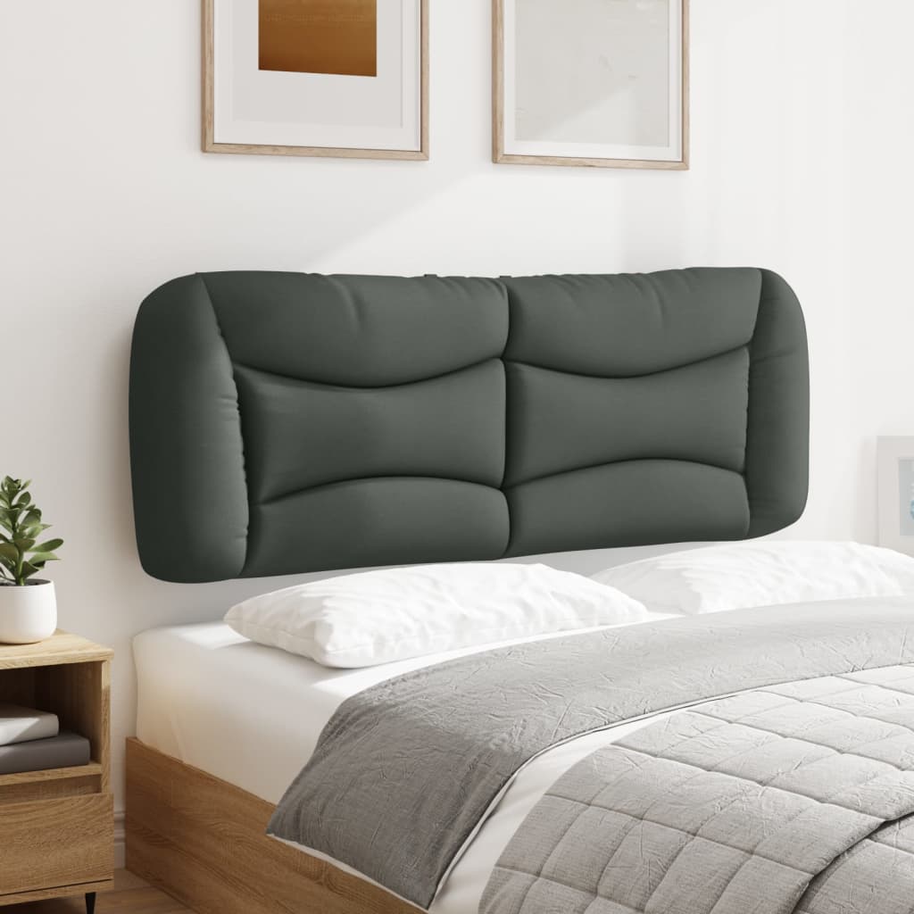 Dark grey upholstered bed frame with tufted headboard and white linens
