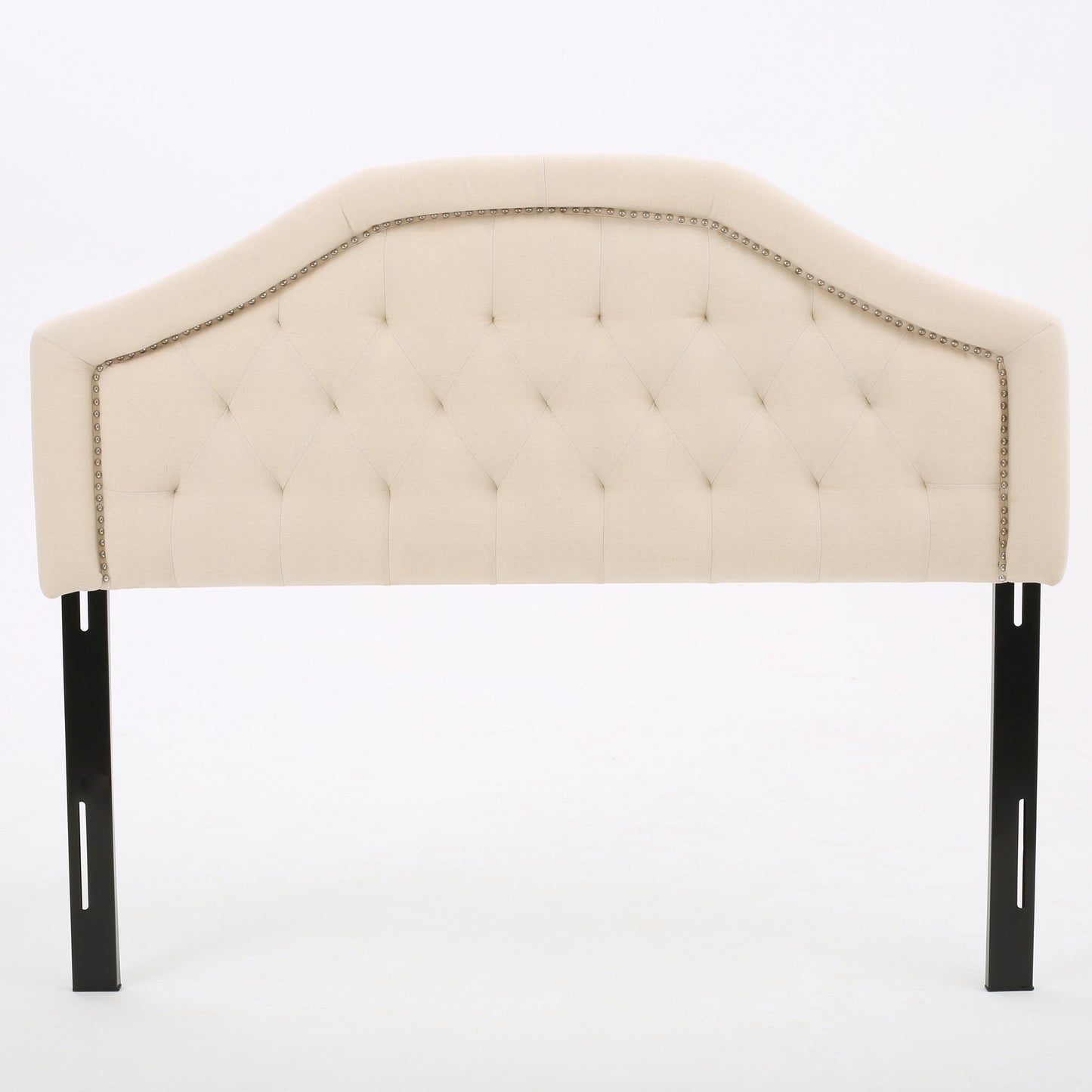 Tufted beige fabric headboard with nailhead trim and black metal legs