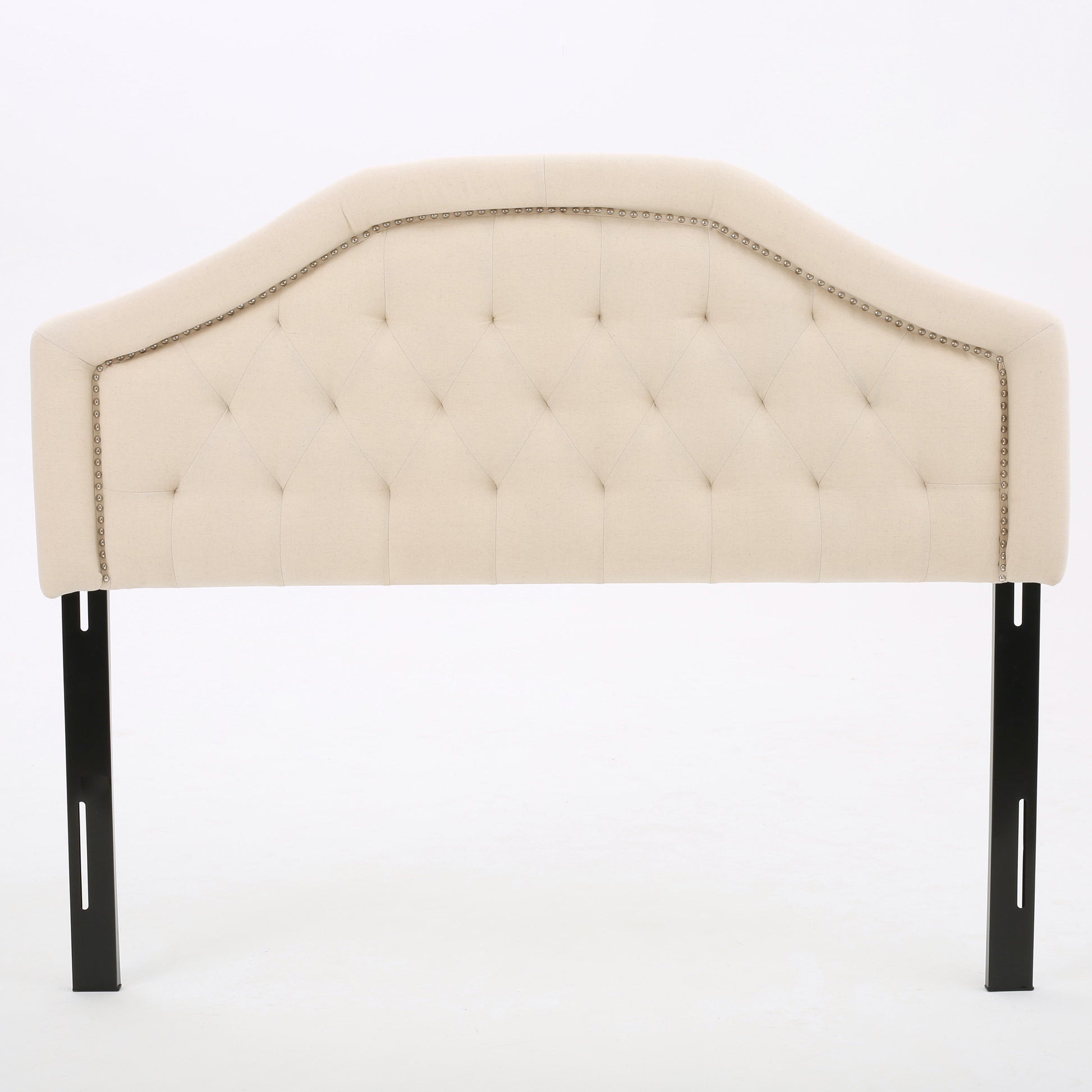 Tufted beige fabric headboard with nailhead trim and black metal legs