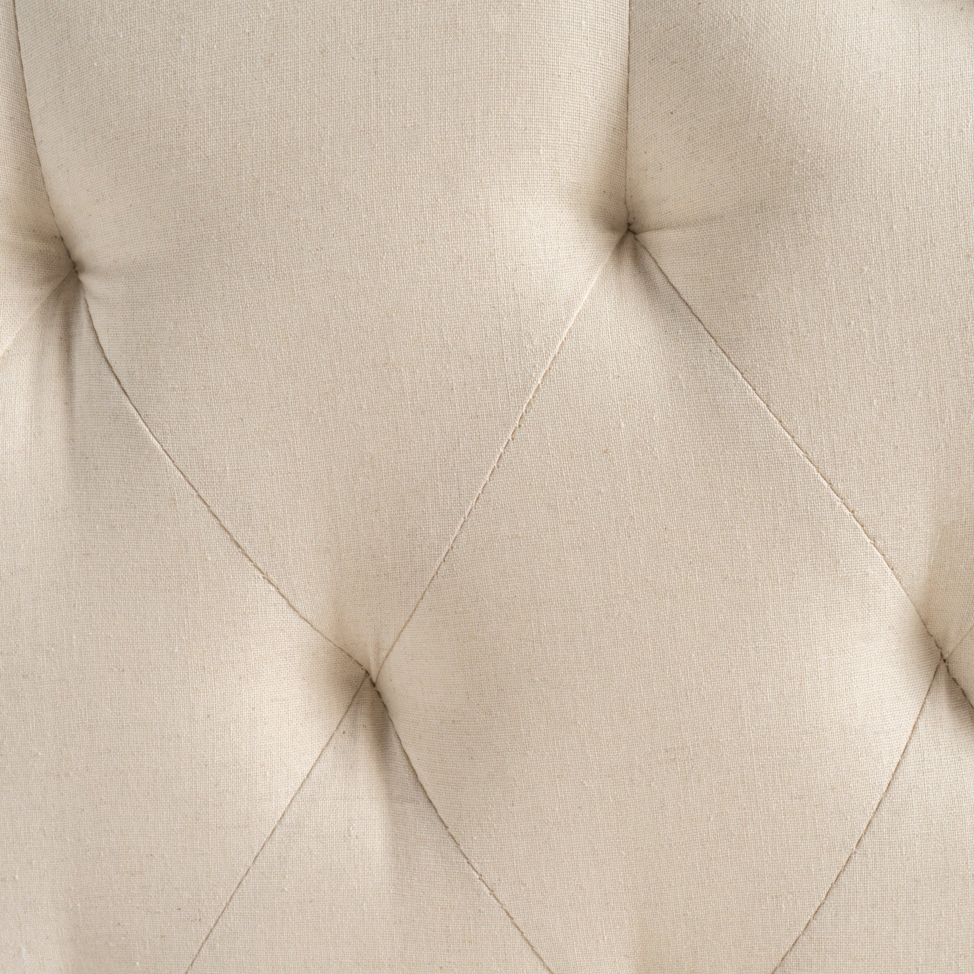 Closeup of tufted beige linen fabric with diamond pattern