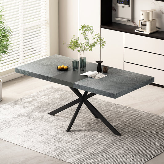 Modern dining table with a textured gray stone top and black metal pedestal base