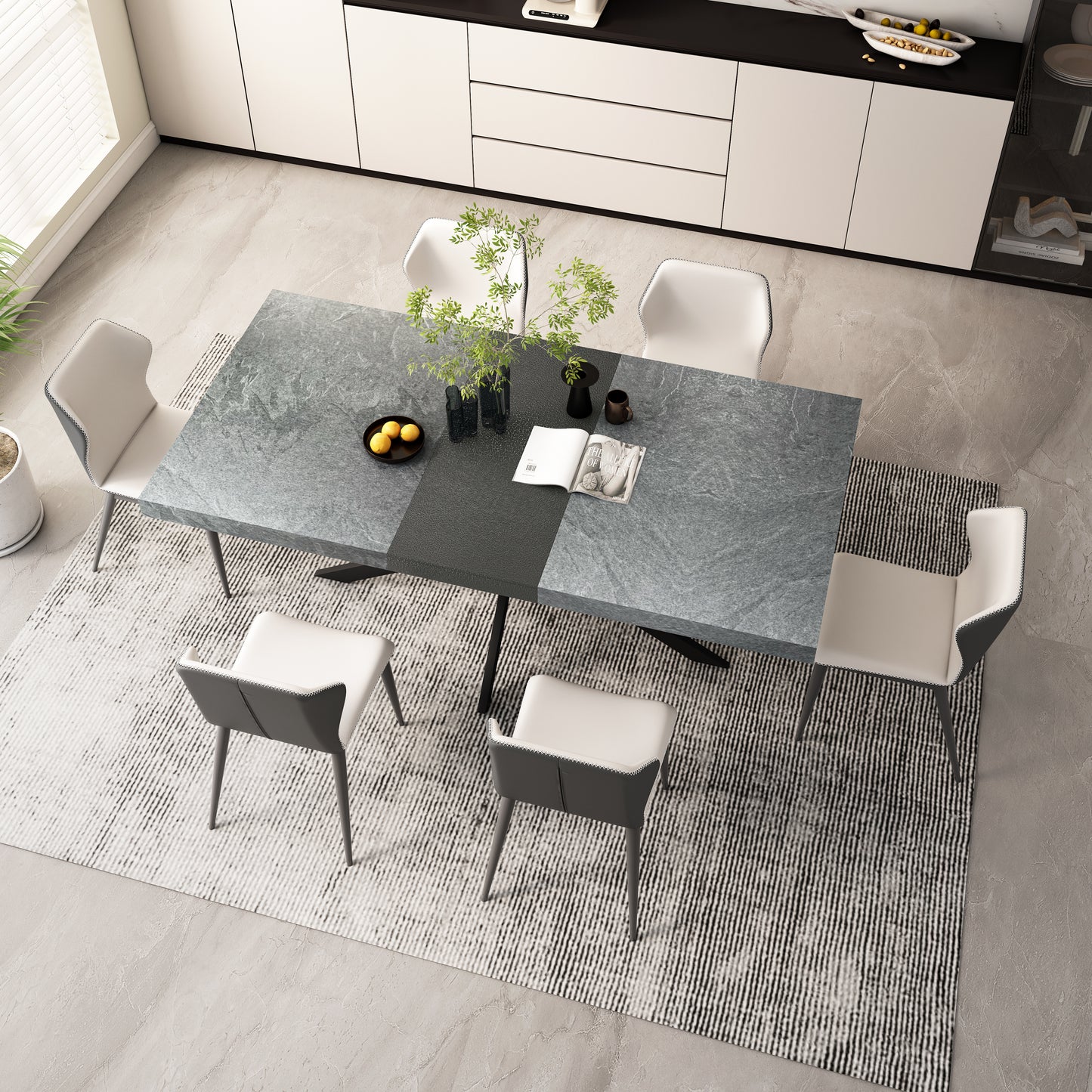 Modern gray stone dining table with white and gray upholstered chairs