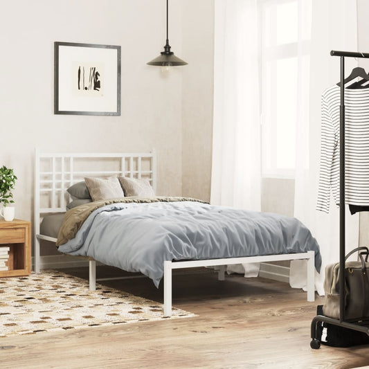 Modern white metal bed frame with a geometric headboard and blue bedding