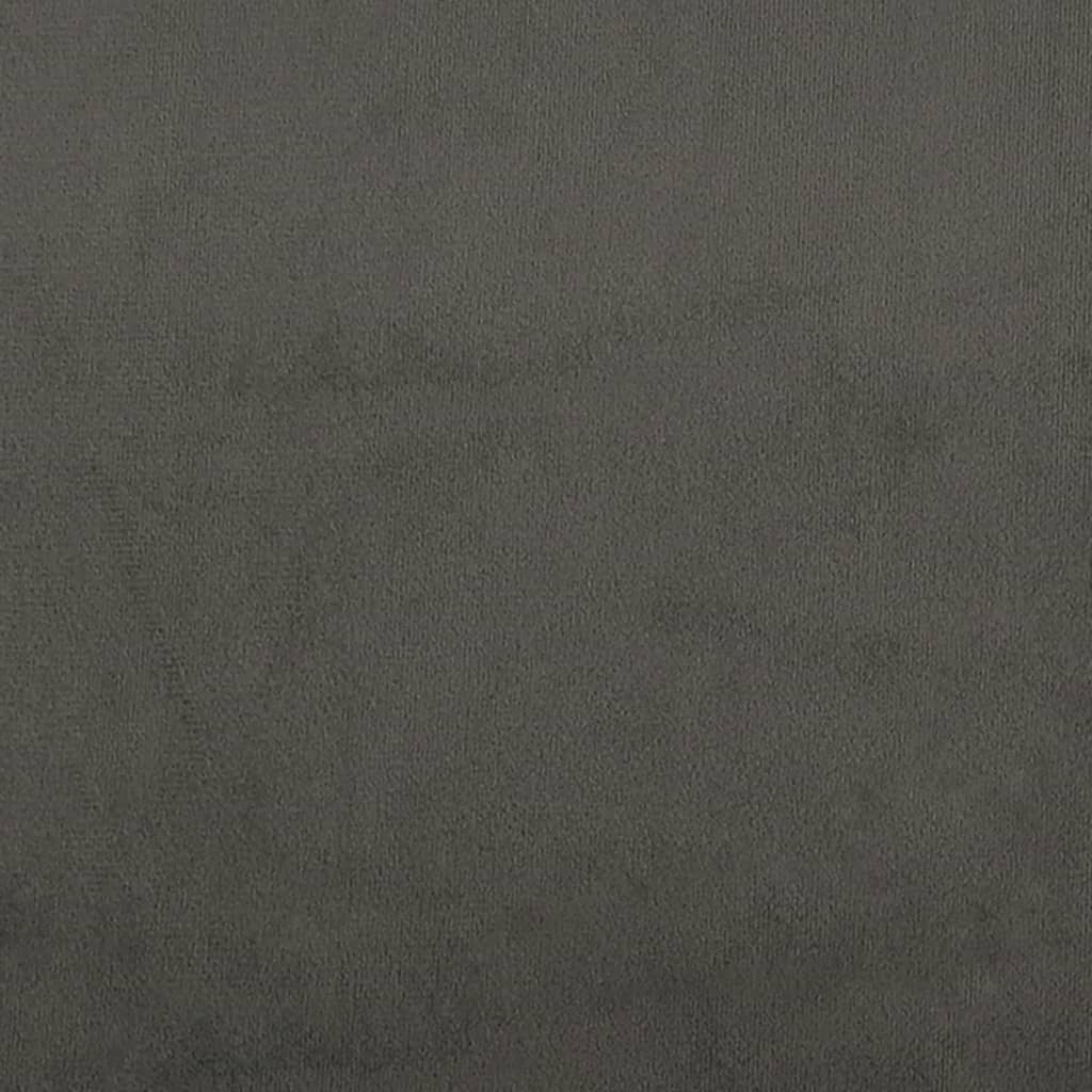 Closeup of a dark gray upholstered bed frame with wooden slats and a black cylindrical leg
