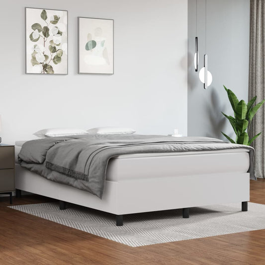 Modern white upholstered platform bed with a gray comforter and white pillows