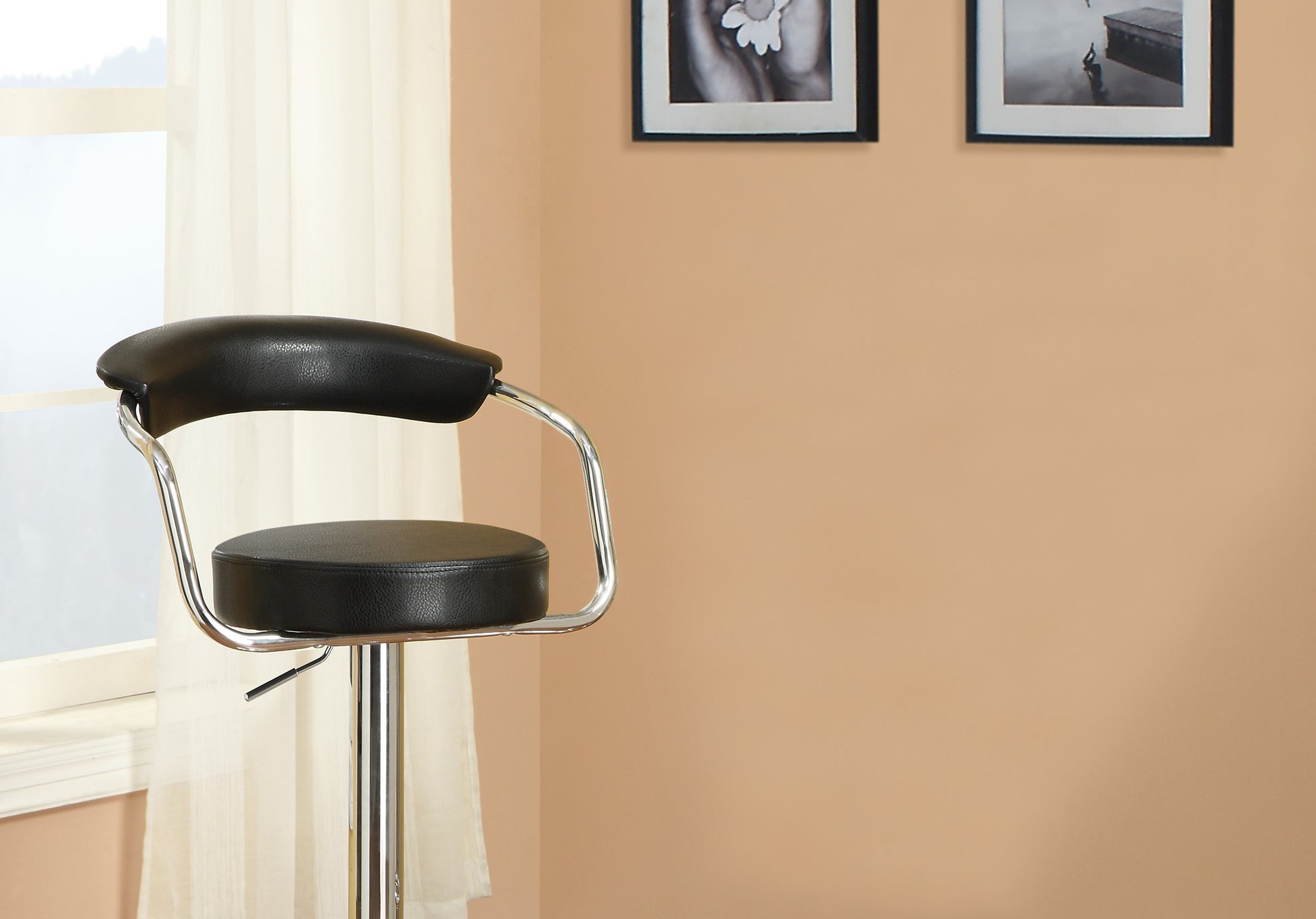 Black leatherette bar stool with chrome base and adjustable height