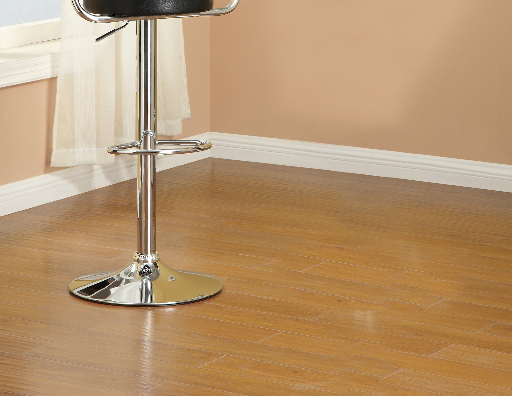 Black leather adjustable bar stool with chrome base and footrest