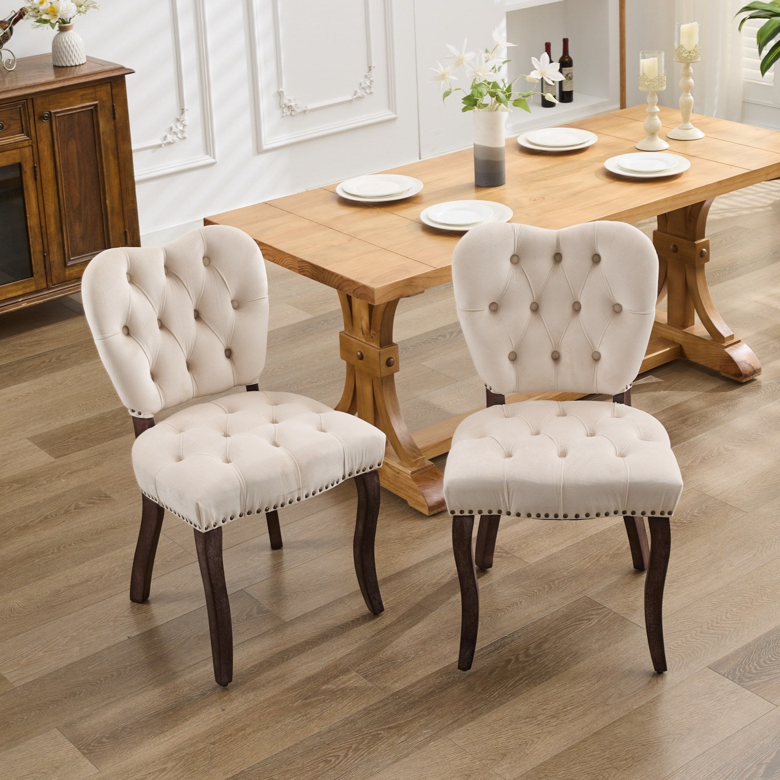 Cream velvet tufted dining chair with dark wood legs and nailhead trim