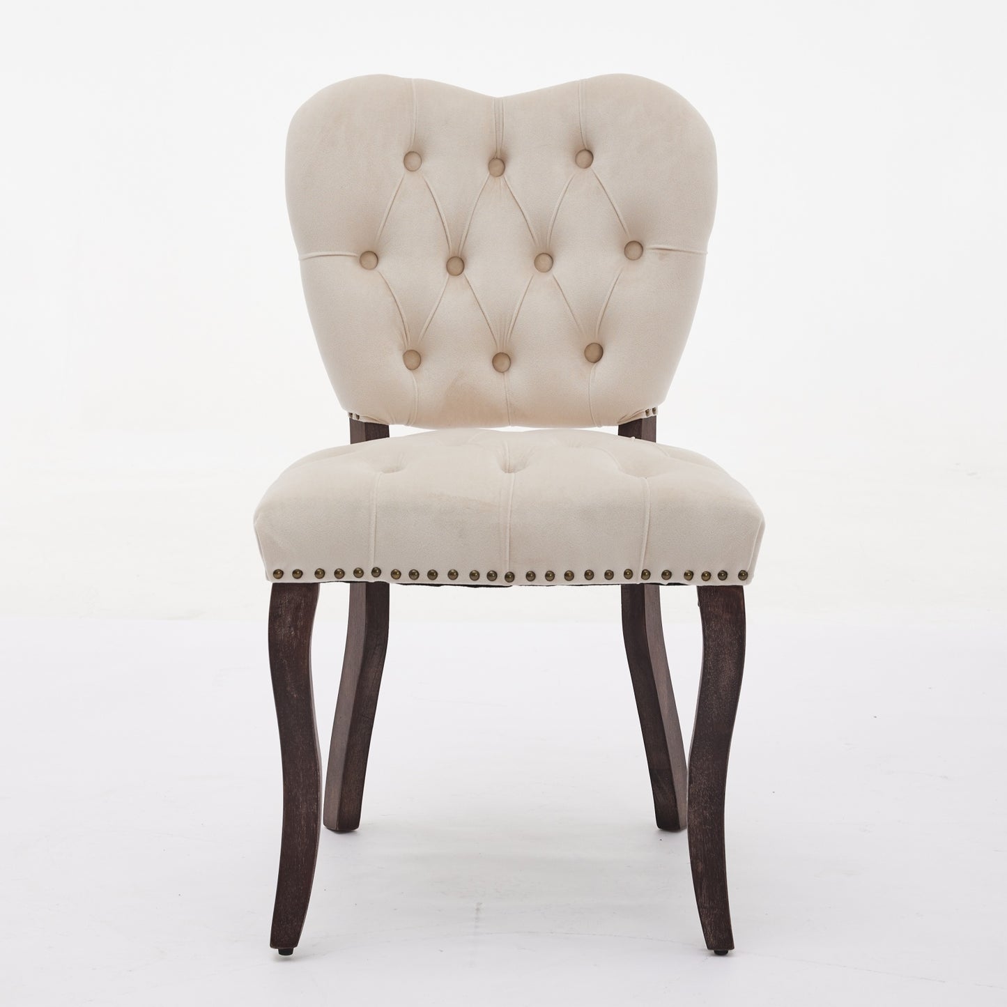 Tufted cream velvet accent chair with dark wood legs and nailhead trim