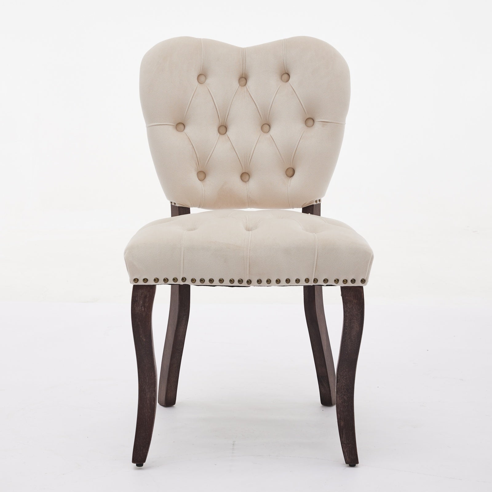 Tufted cream velvet accent chair with dark wood legs and nailhead trim