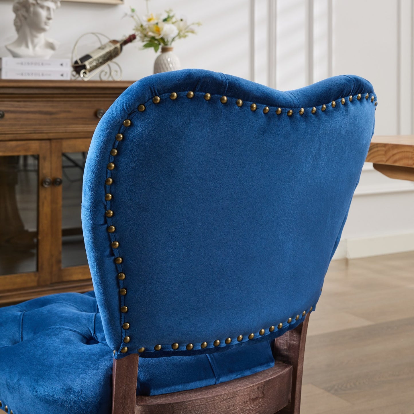 Deep blue velvet accent chair with brass nailhead trim and tufted seat