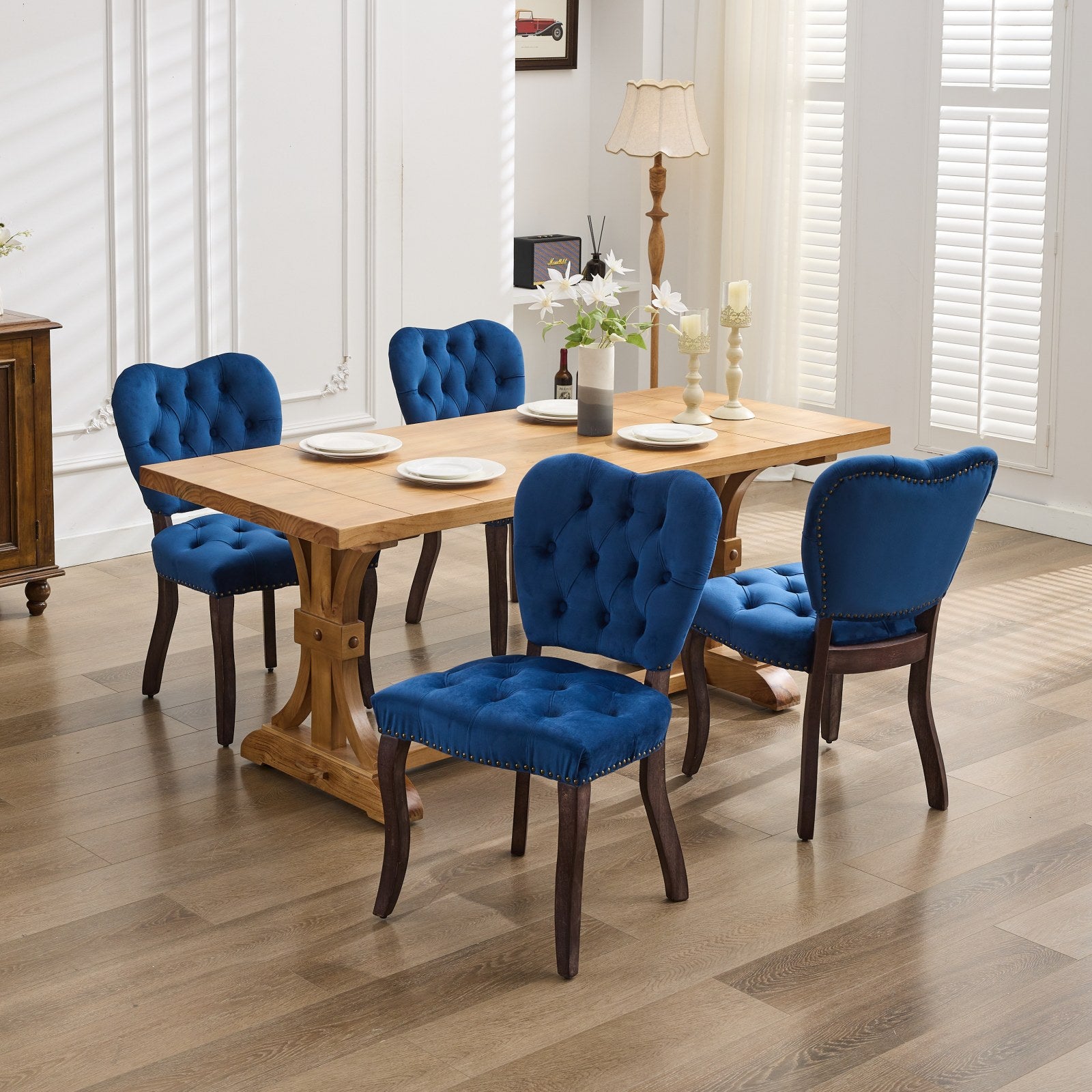 Blue velvet tufted dining chair with nailhead trim