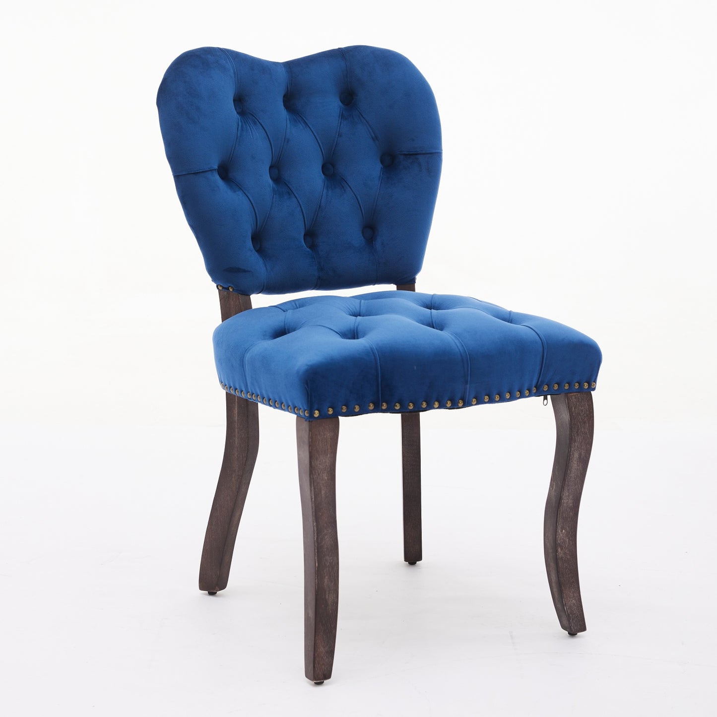 Tufted navy blue velvet accent chair with dark wooden legs and brass nailhead trim
