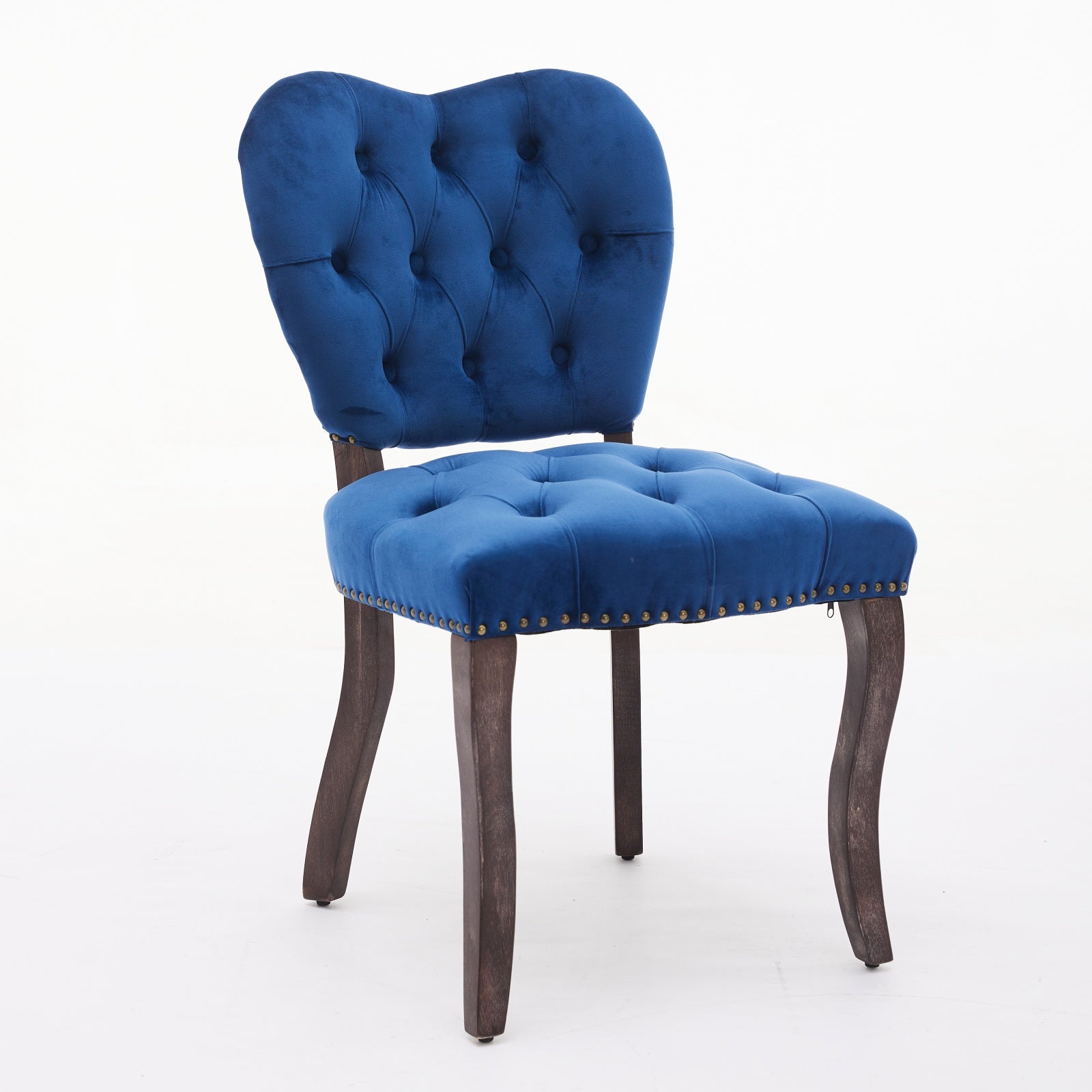 Tufted navy blue velvet accent chair with dark wooden legs and brass nailhead trim