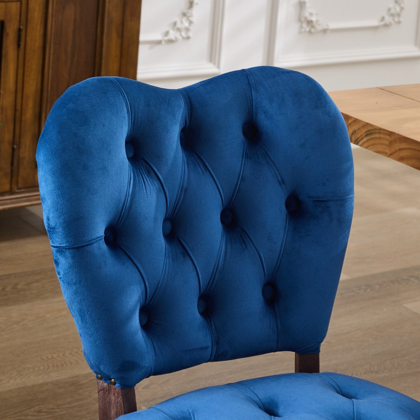 Deep blue velvet armchair with tufted back and seat