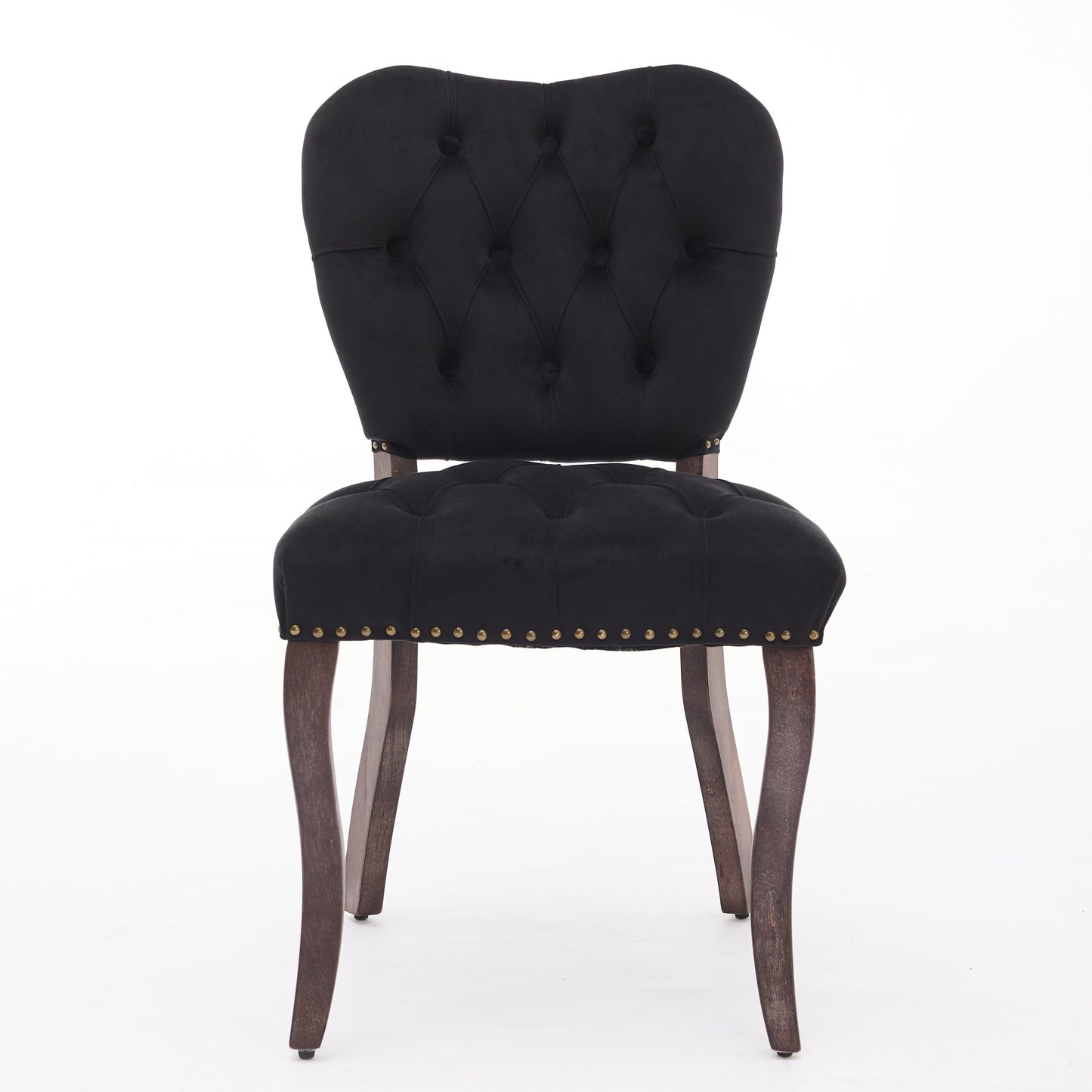 Black velvet armchair with tufted back and brass nailhead trim