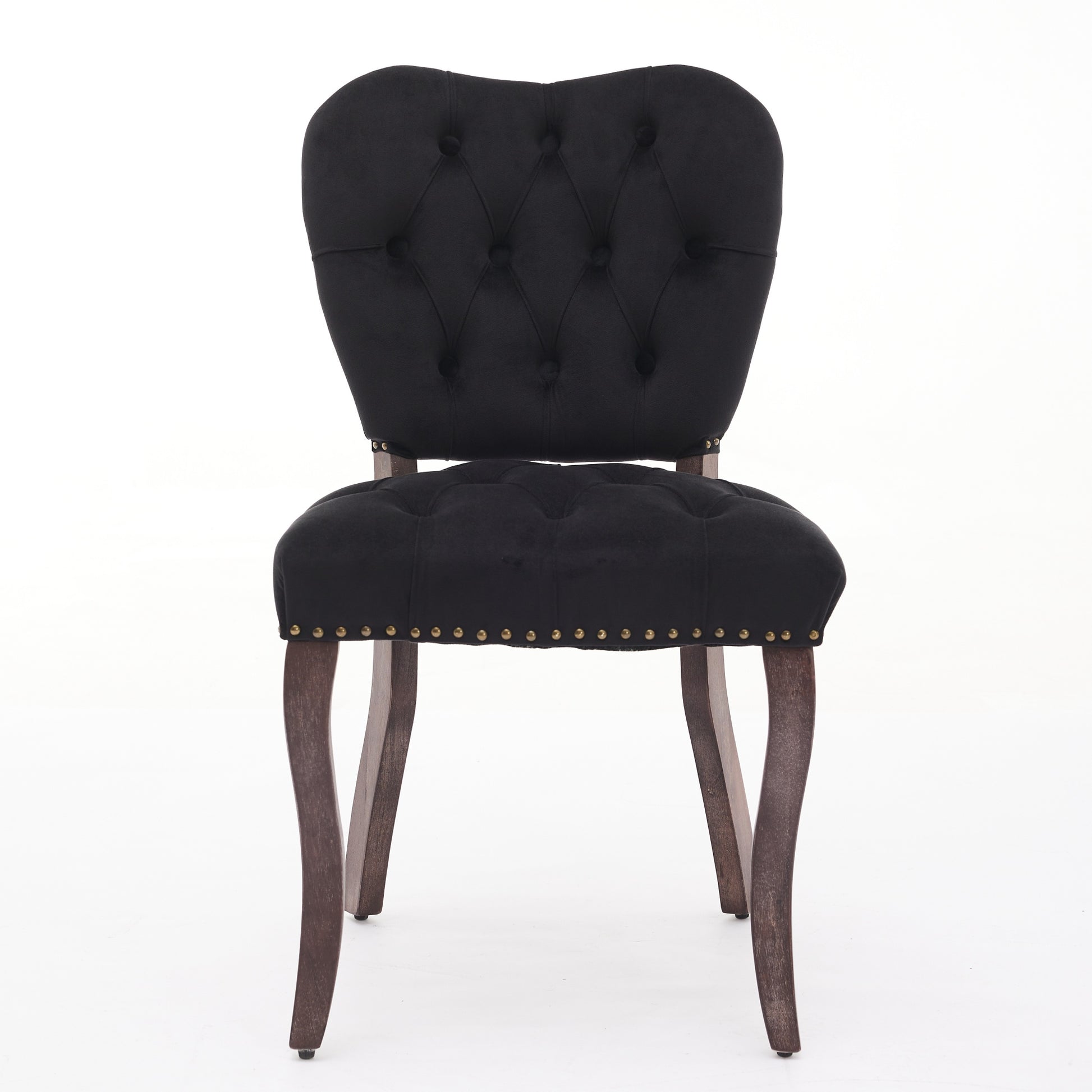 Black velvet armchair with tufted back and brass nailhead trim