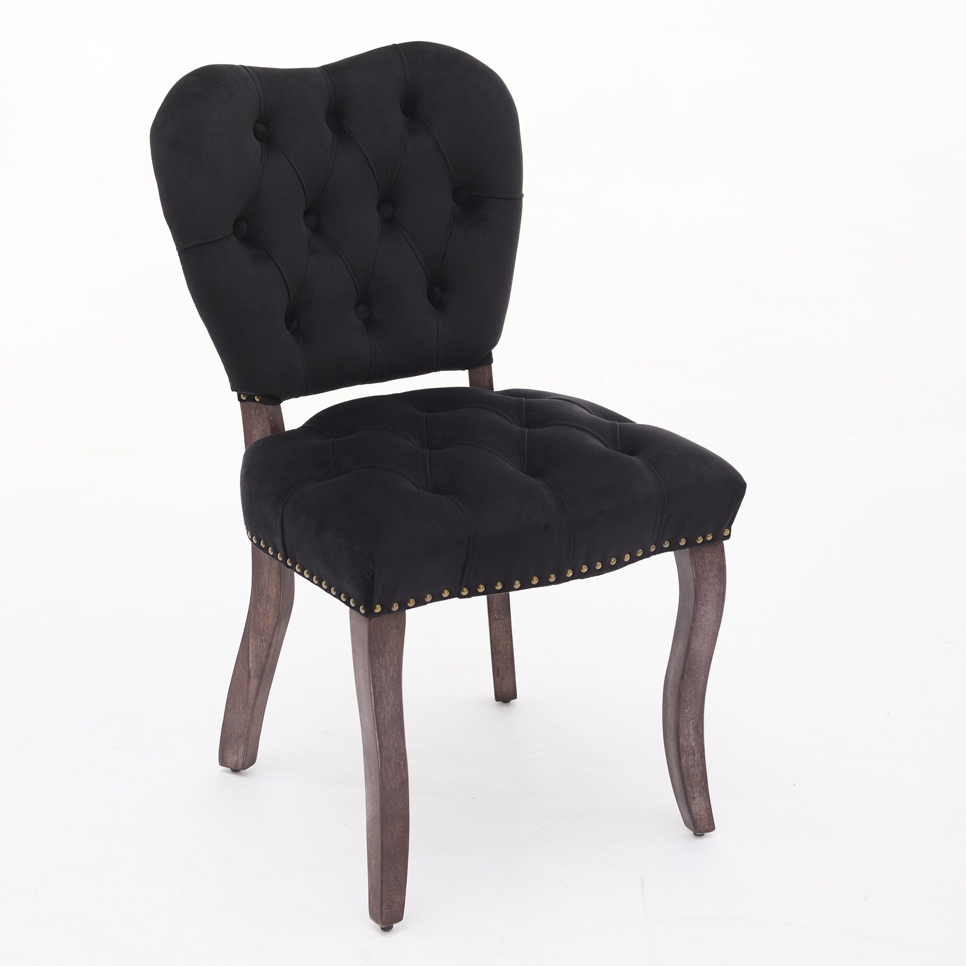 Black velvet tufted accent chair with brass nailhead trim