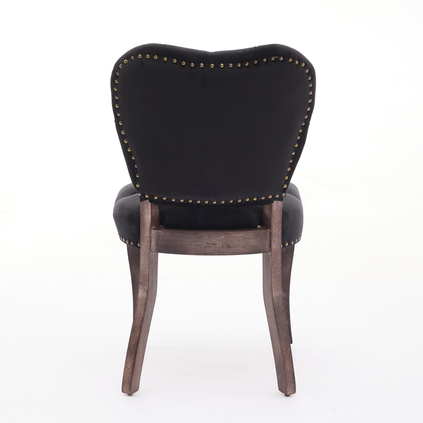 Black velvet dining chair with brass nailhead trim and dark wood legs