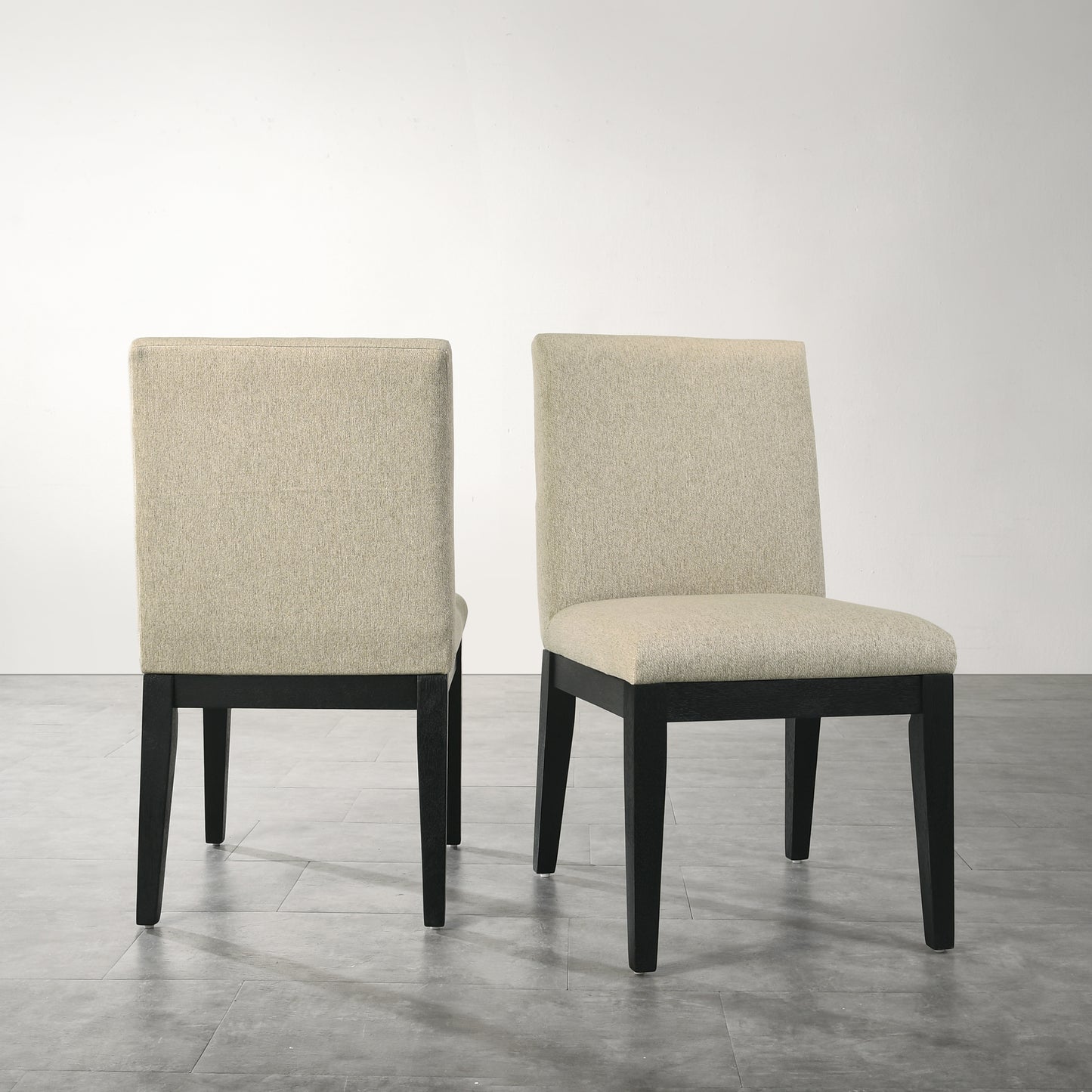 Beige upholstered dining chair with dark wood legs