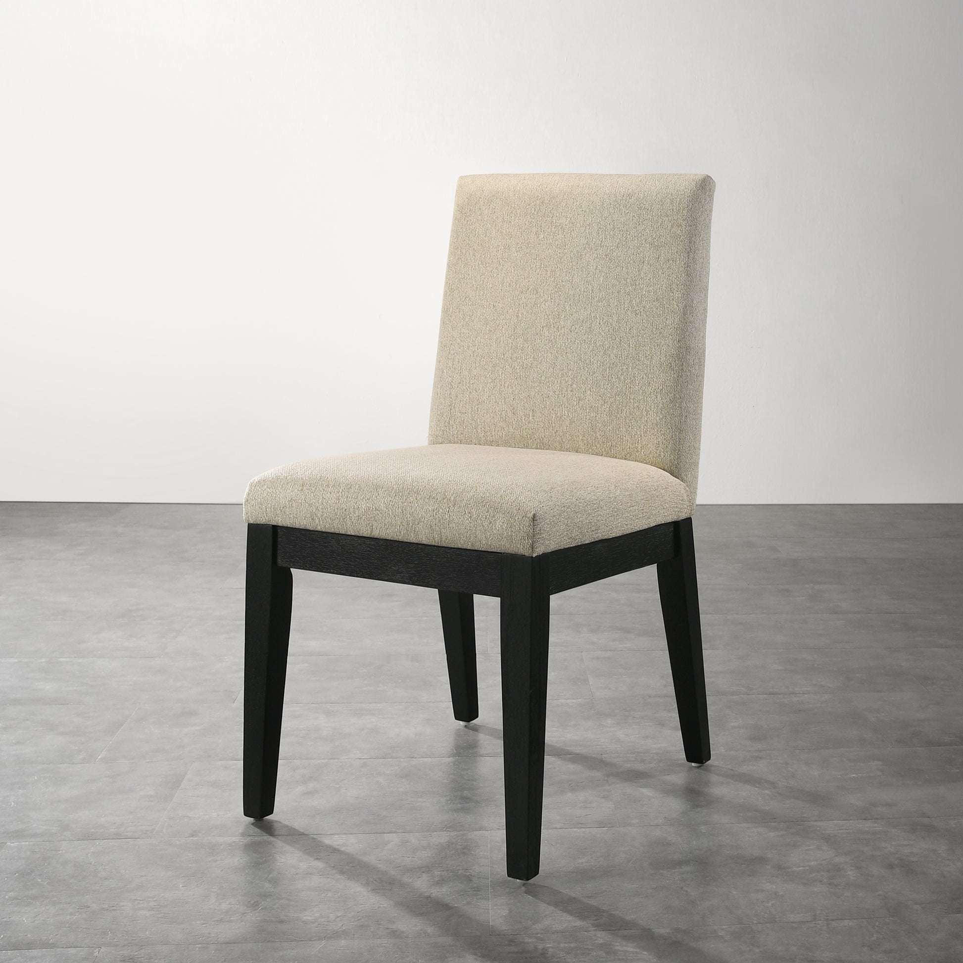 Cream upholstered dining chair with dark wood legs