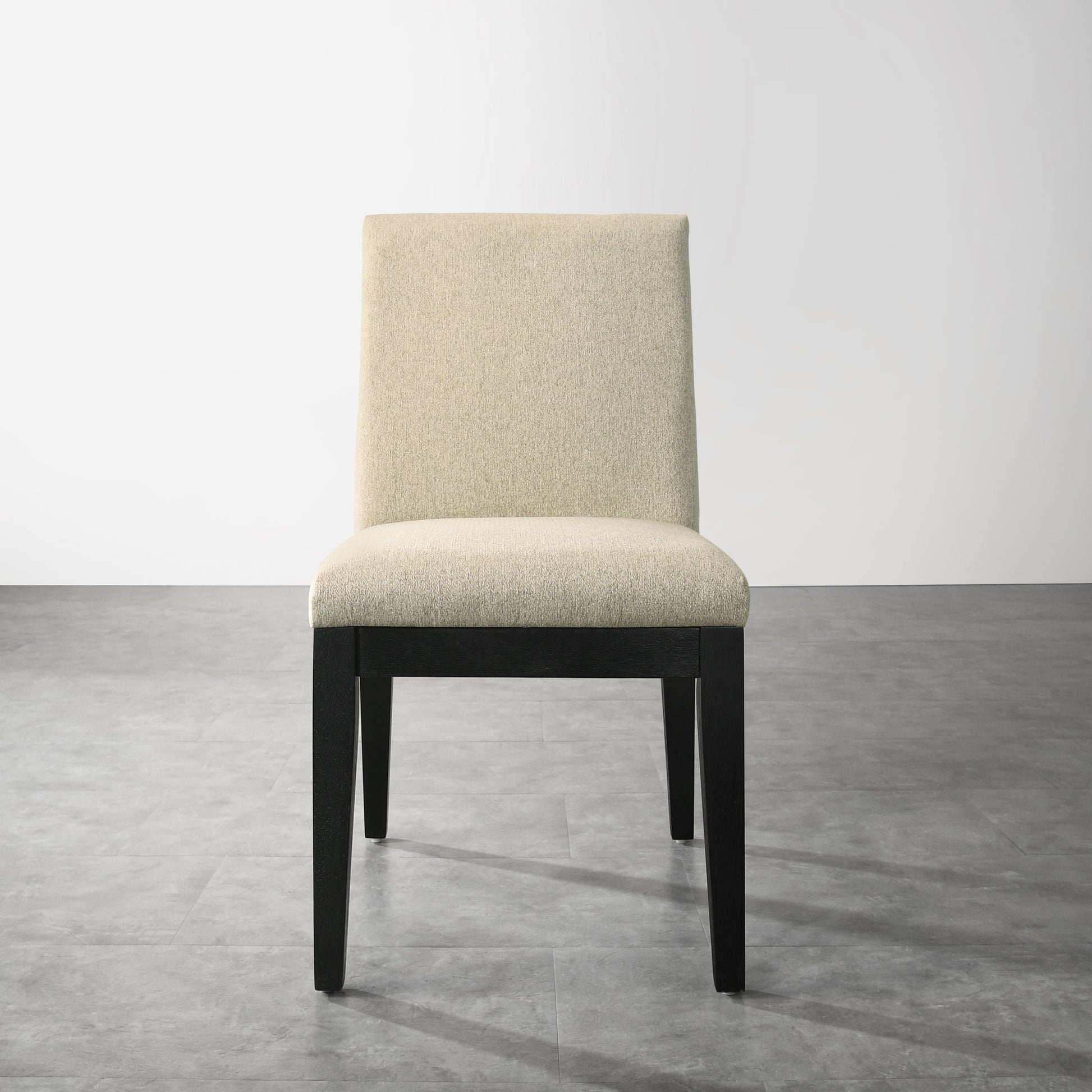 Beige upholstered dining chair with dark wood legs