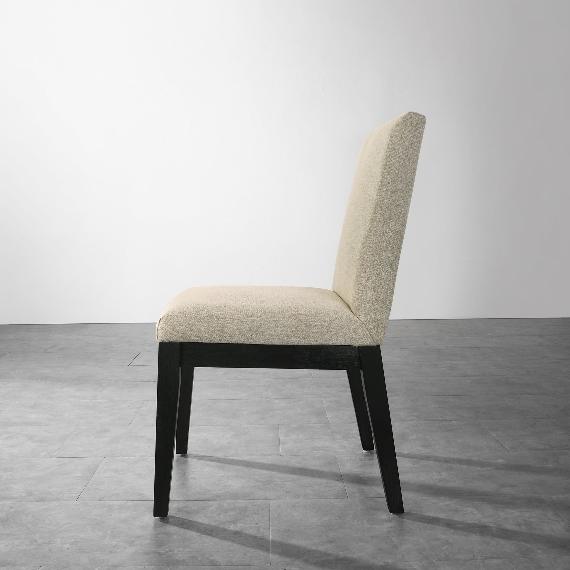 Textured beige dining chair with dark wood legs