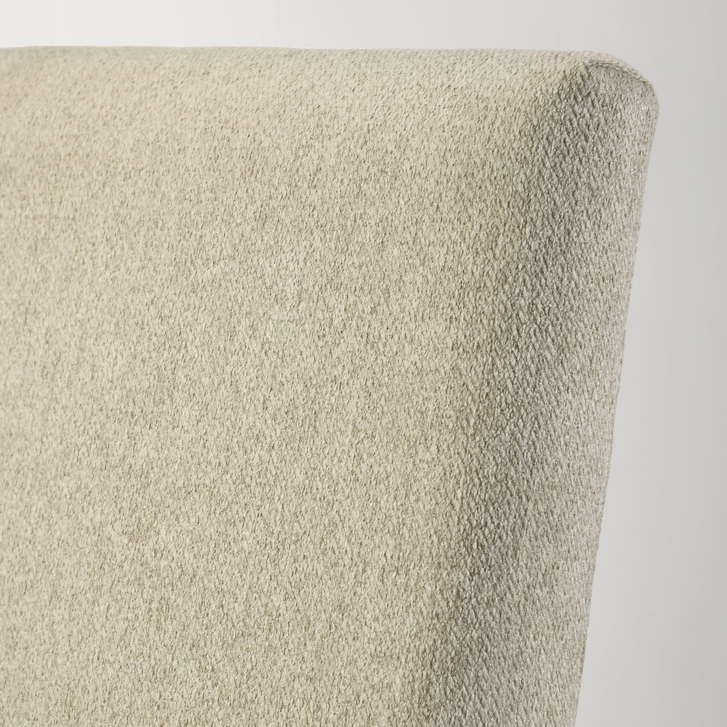 Closeup of textured beige fabric on a modern chair back