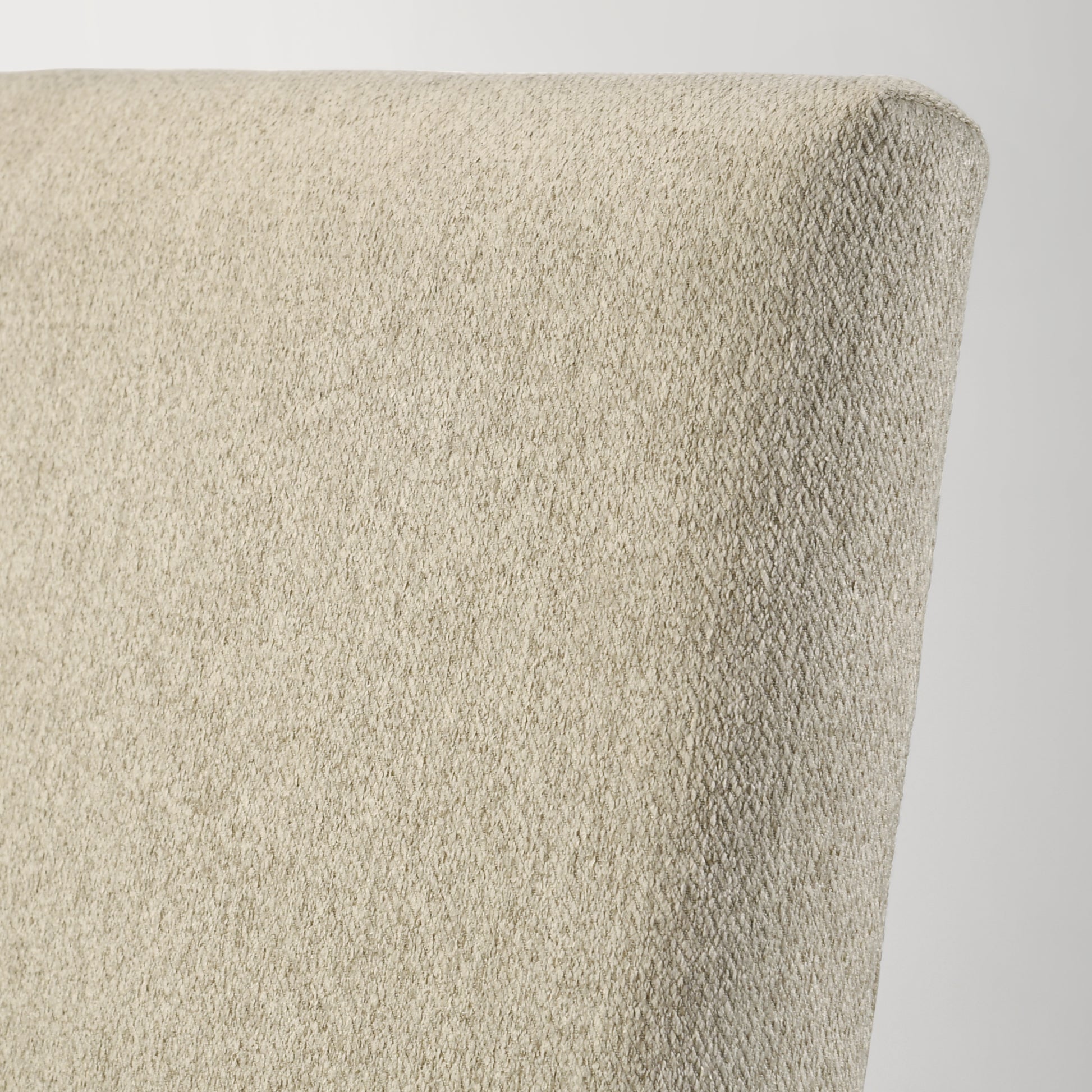 Closeup of textured beige fabric on a modern chair back