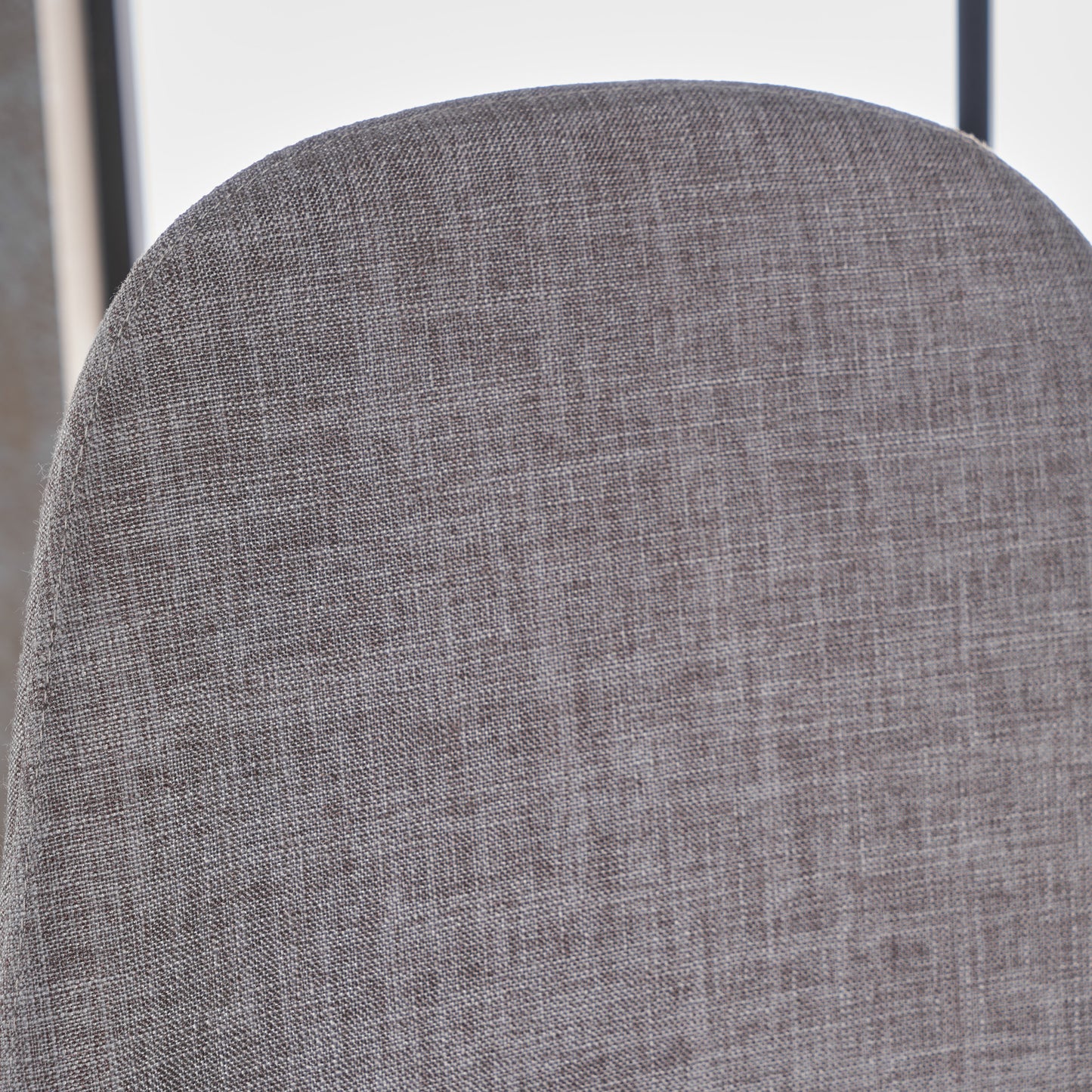 Closeup of textured gray woven fabric on the back of a chair