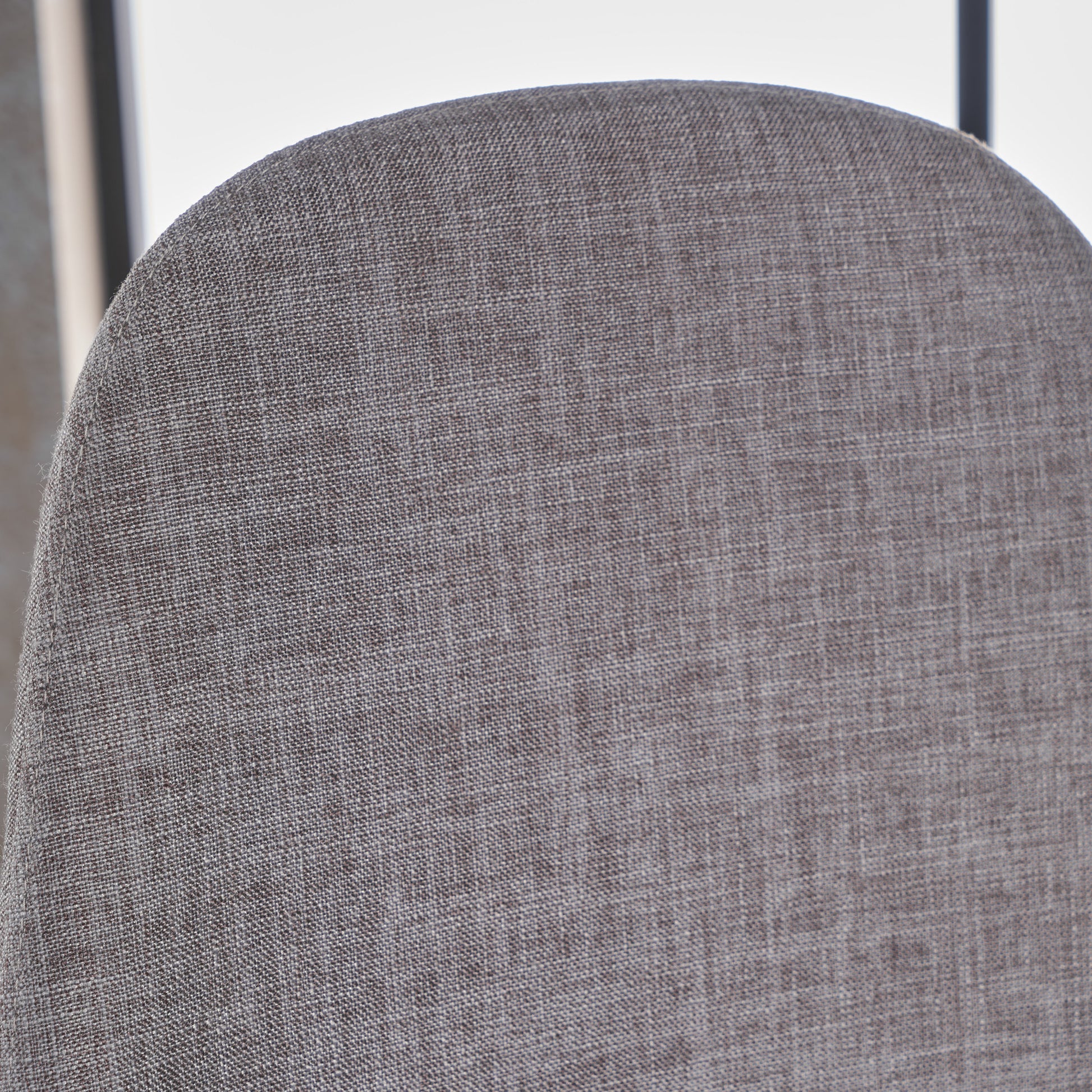 Closeup of textured gray woven fabric on the back of a chair