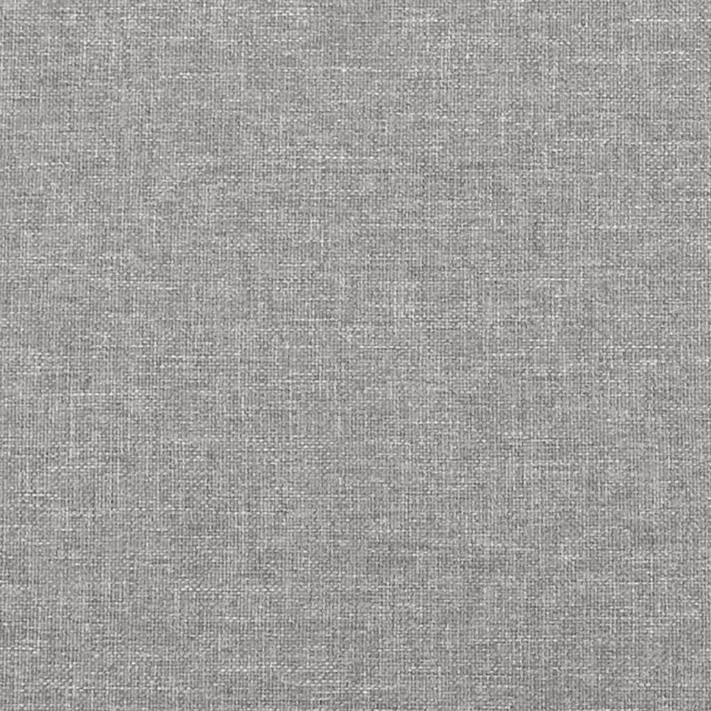 Closeup of grey fabric bed frame with black cylindrical legs