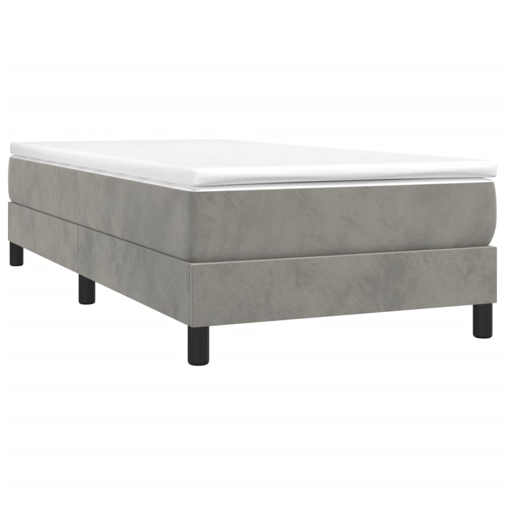 Single bed frame with gray upholstered base and white mattress