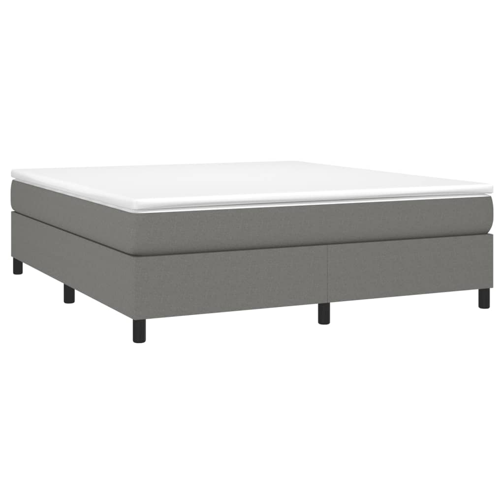 Grey upholstered bed base with white mattress and black legs