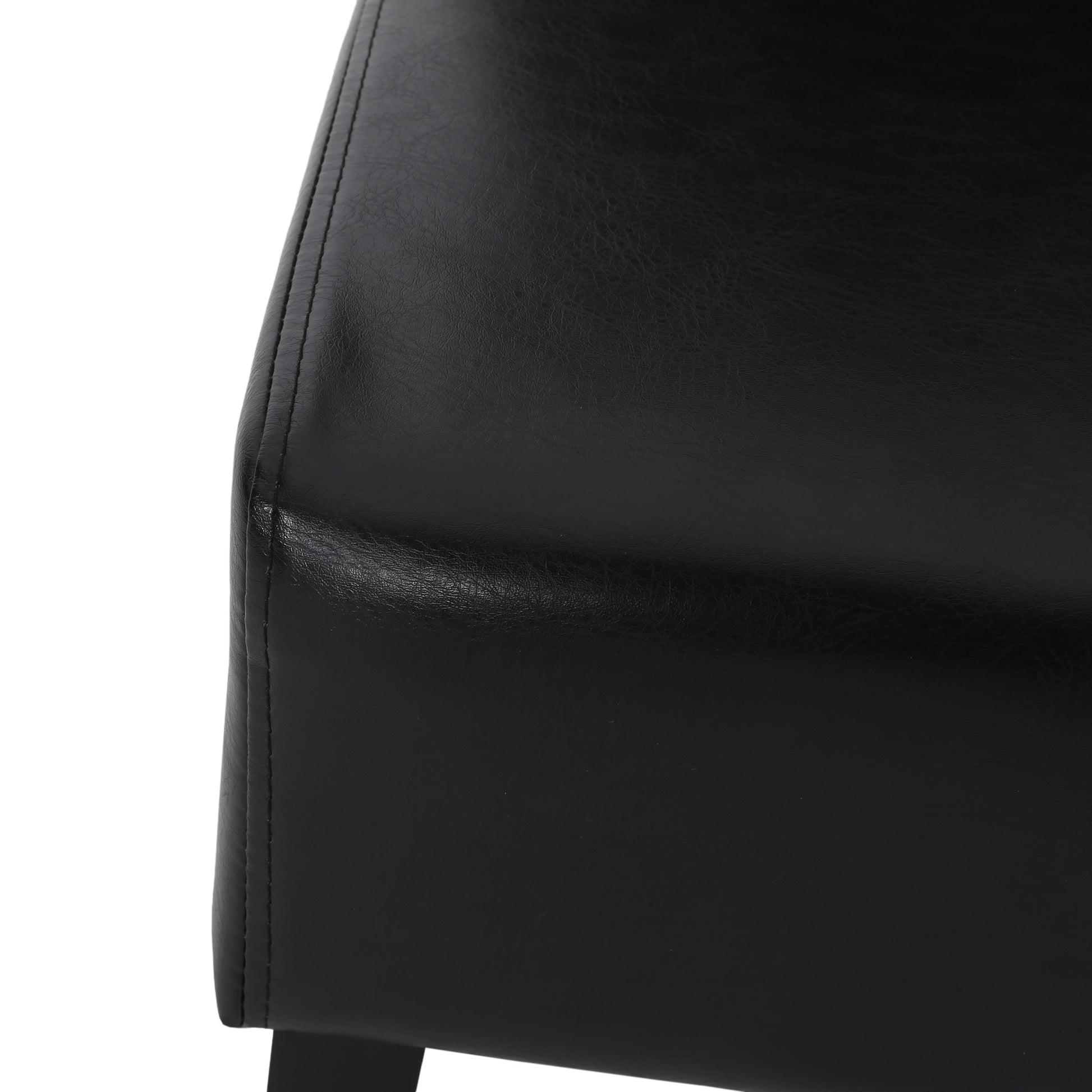 Black leather chair detail with visible stitching