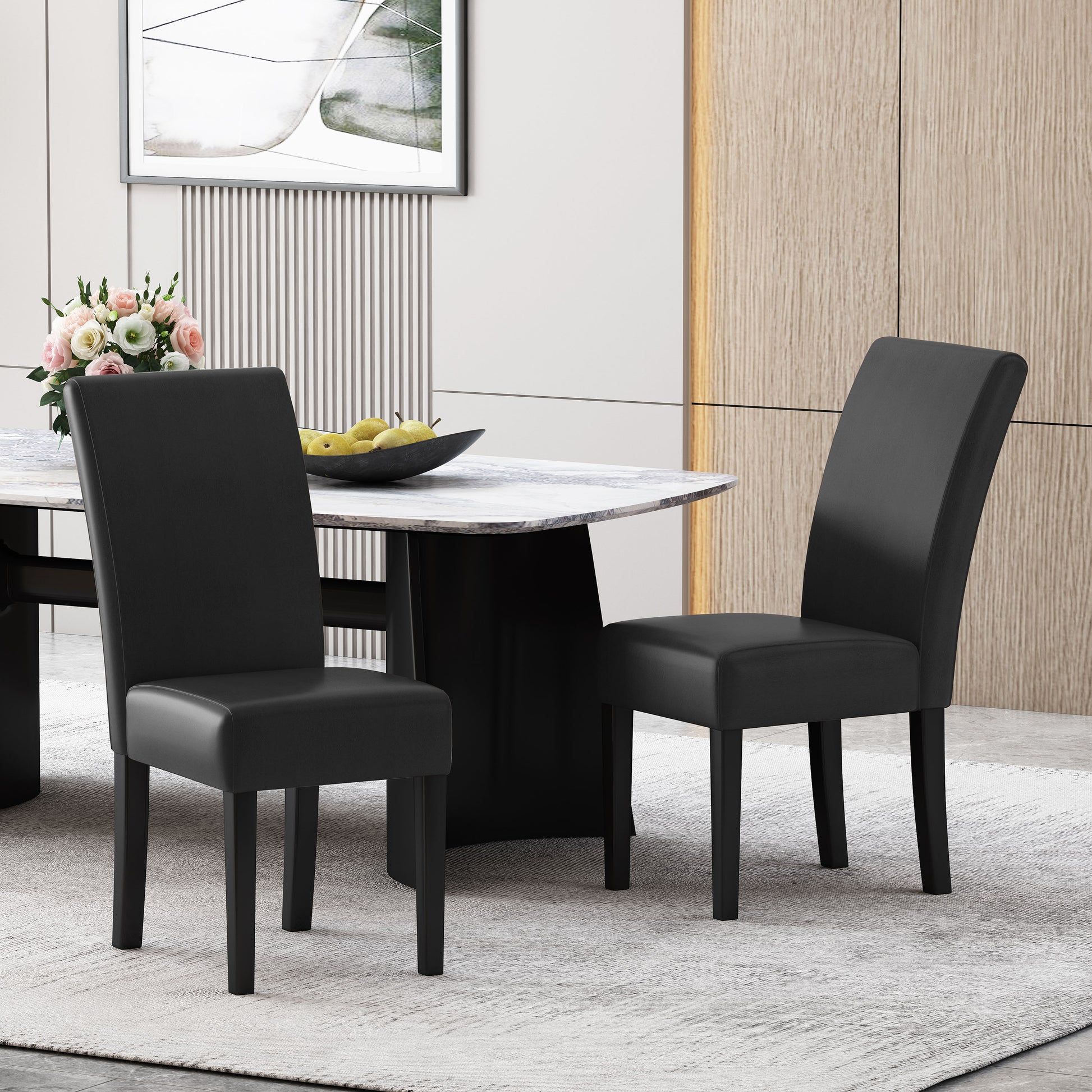 Two black faux leather dining chairs with wooden legs