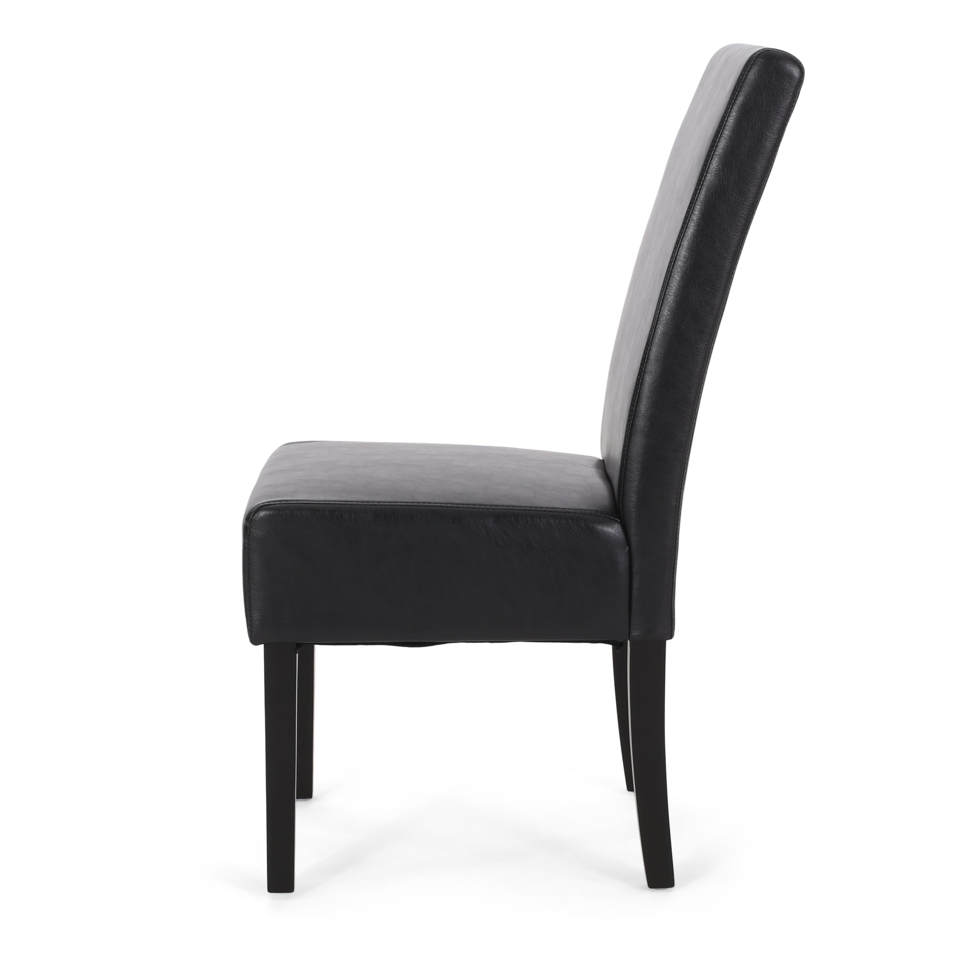 Side view of a black faux leather dining chair with tapered legs