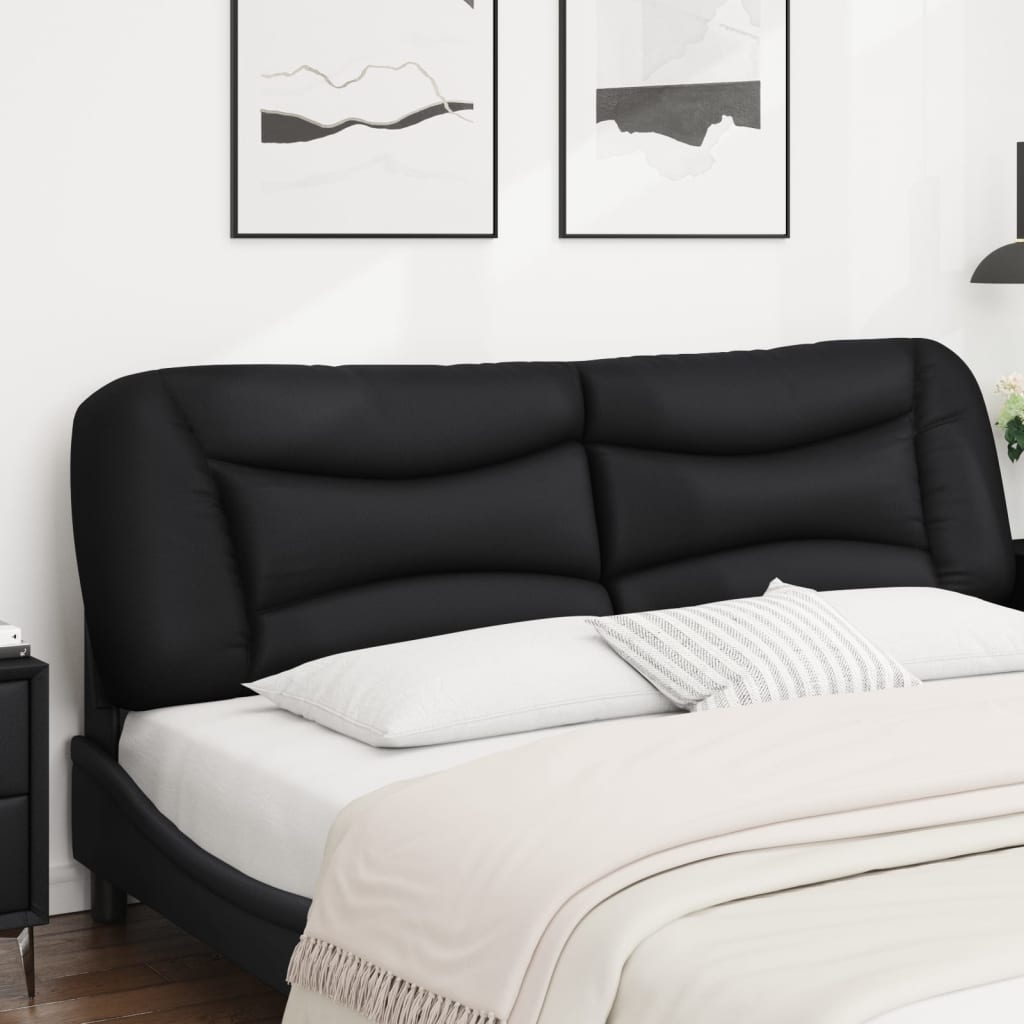 Black upholstered headboard with tufted panels attached to a bed