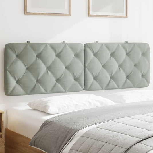 Light gray upholstered headboard with diamond tufting mounted above a bed